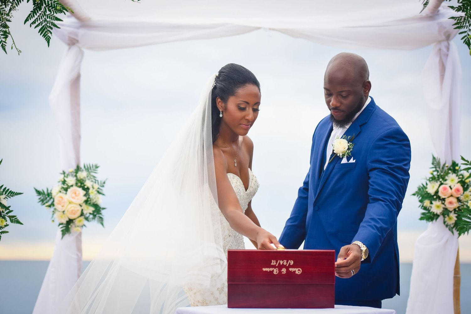 Intimate wedding ceremony moments under white canopy with peach and green floral decor.