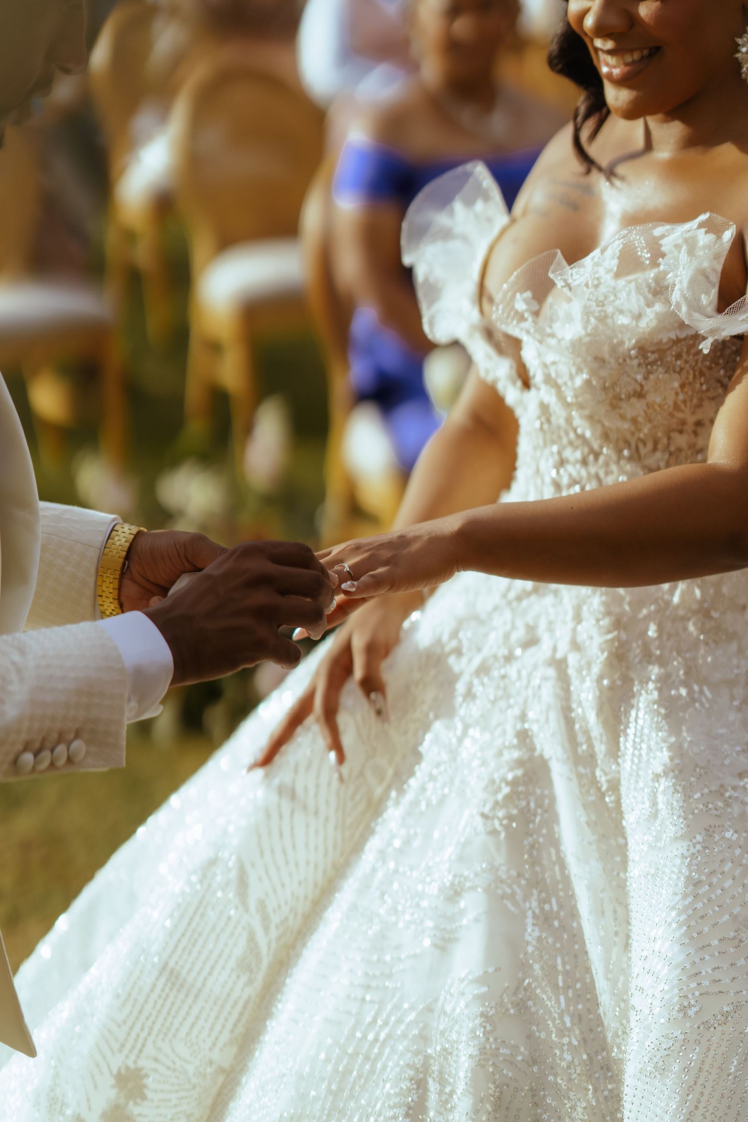 Close-up details of a sparkly white wedding dress with beaded embellishments.