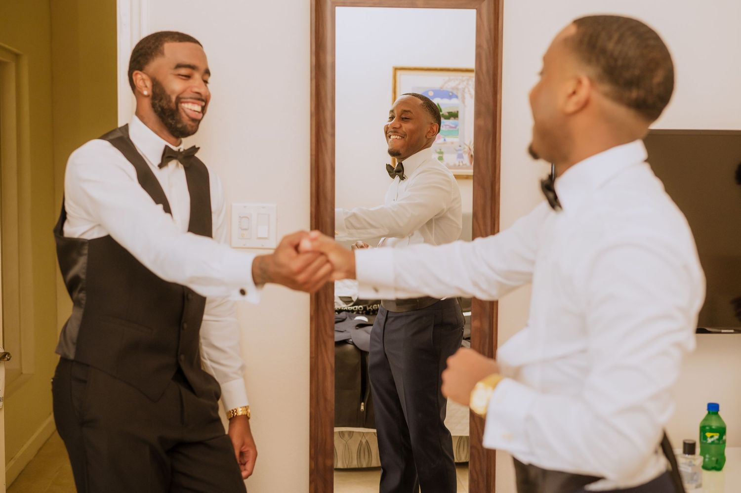 Two people in formal attire sharing playful moments while getting ready for a special occasion.