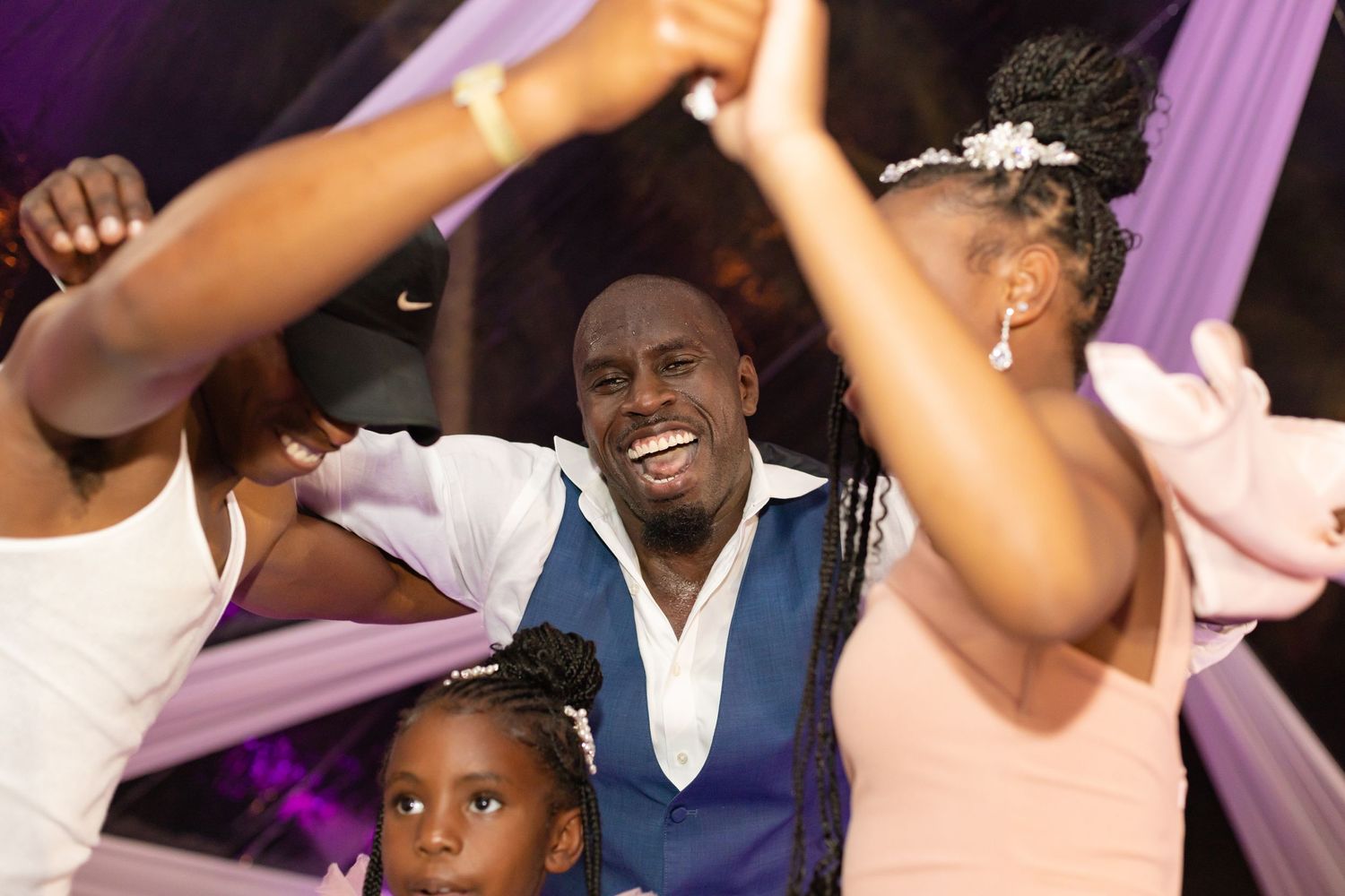 Energetic wedding reception celebration with guests throwing money in the air.