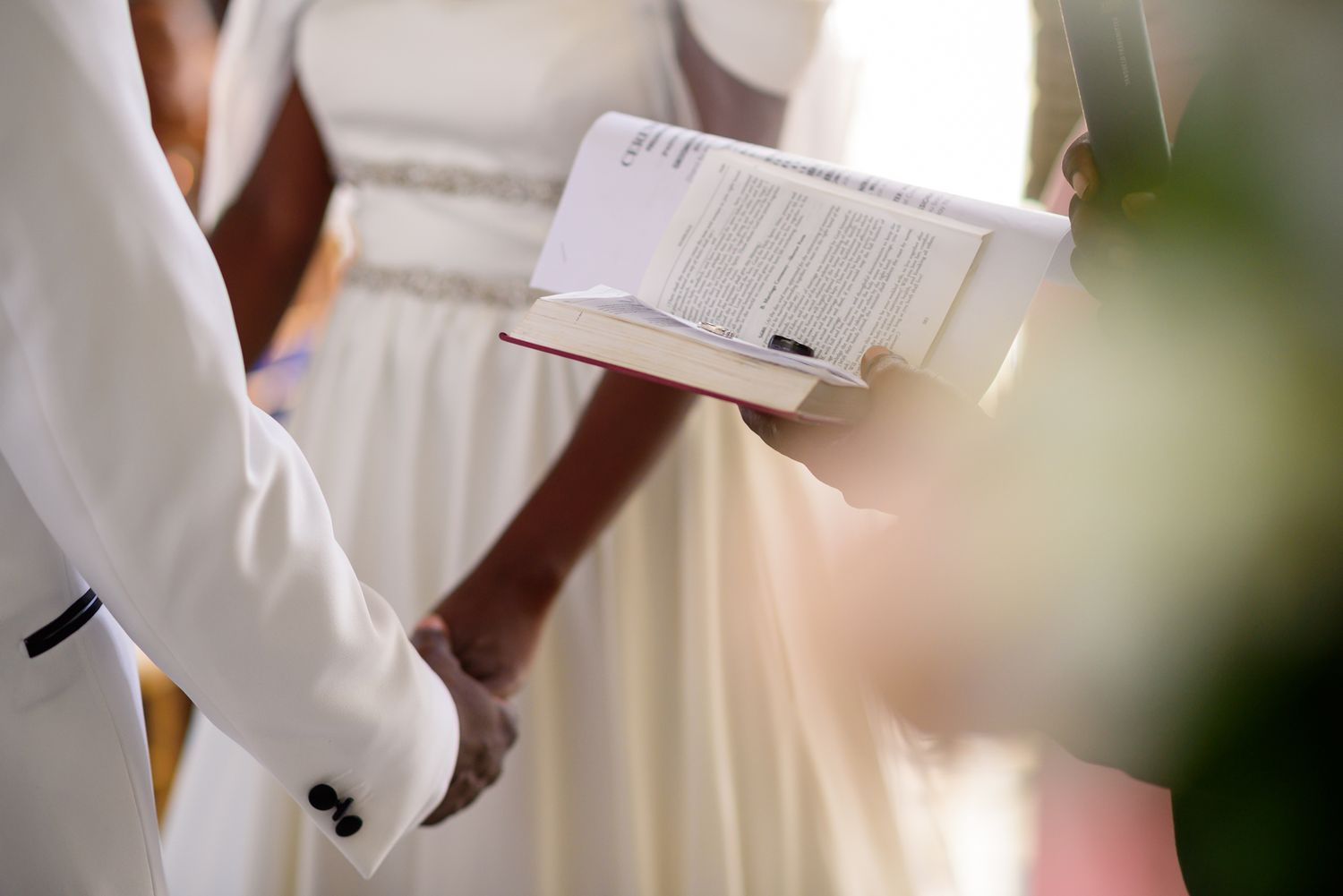 Wedding ceremony details showing formal attire and floral arrangements.