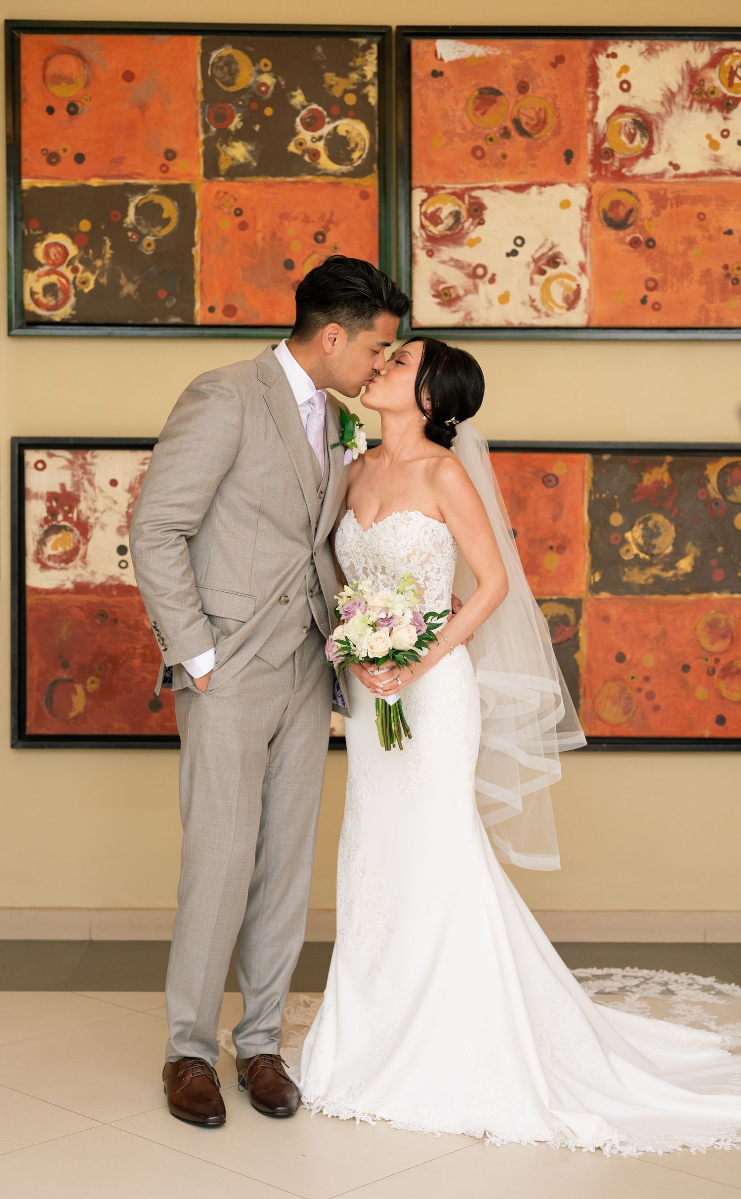 Romantic wedding portraits captured against colorful modern art wall panels.