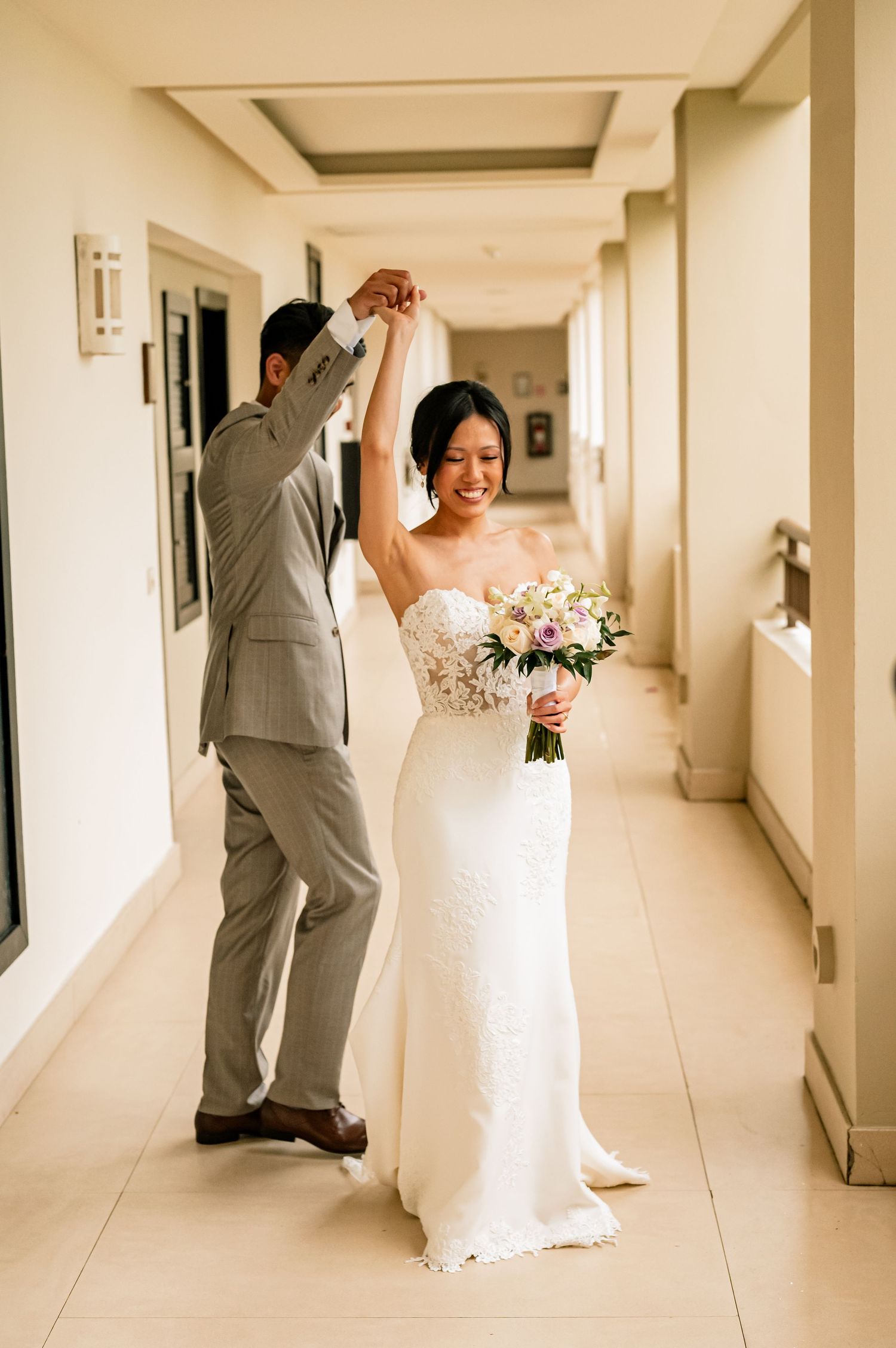 Emotional first look sequence showing bride and groom meeting in a bright hallway.
