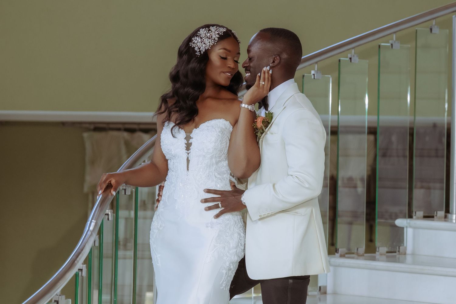 Romantic wedding couple shares intimate moments on an elegant staircase.