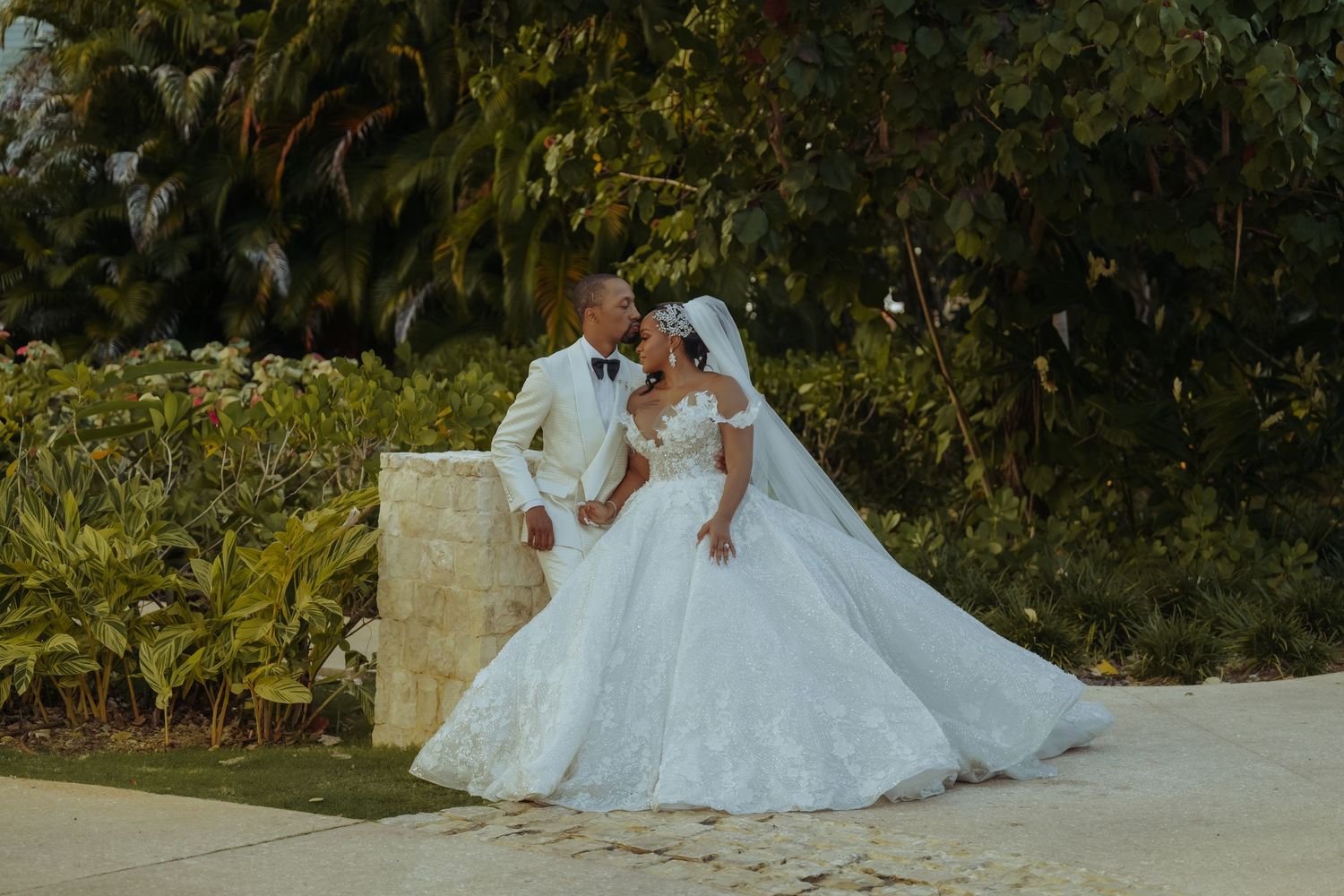 Wedding celebration in a lush garden setting with elegant decor and lighting.