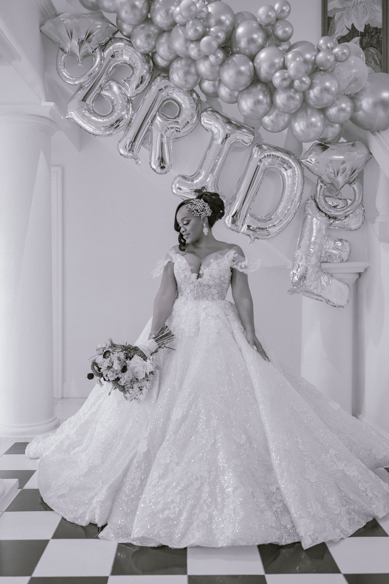 Elegant bridal portraits featuring a white wedding dress with decorative silver balloons and flowers.