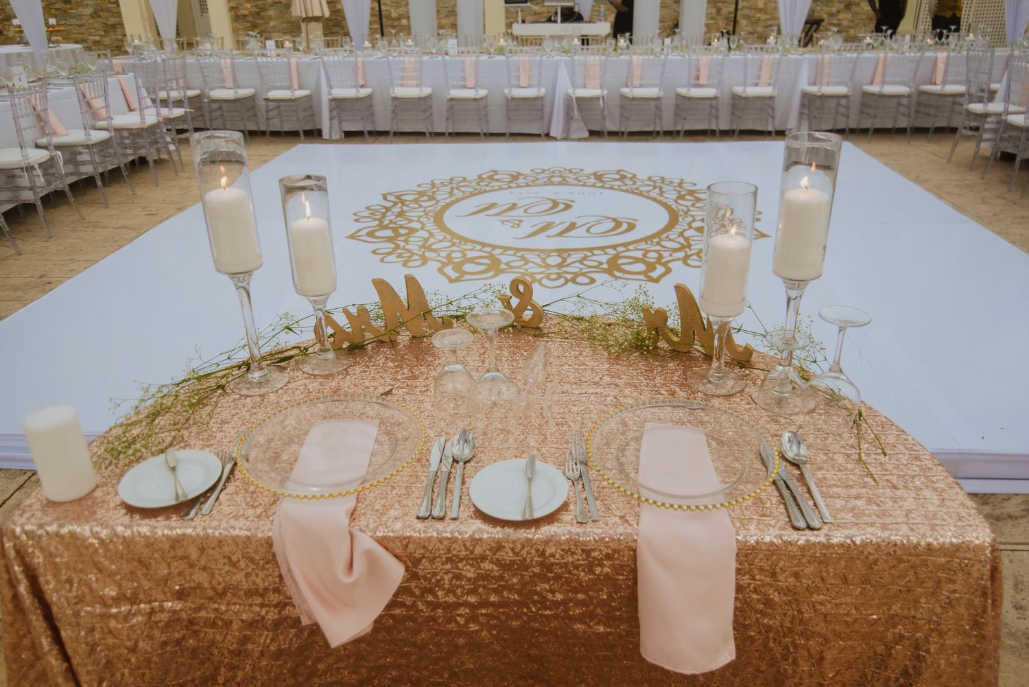 Romantic sweetheart table setting with rose gold sequin tablecloth and monogrammed dance floor.