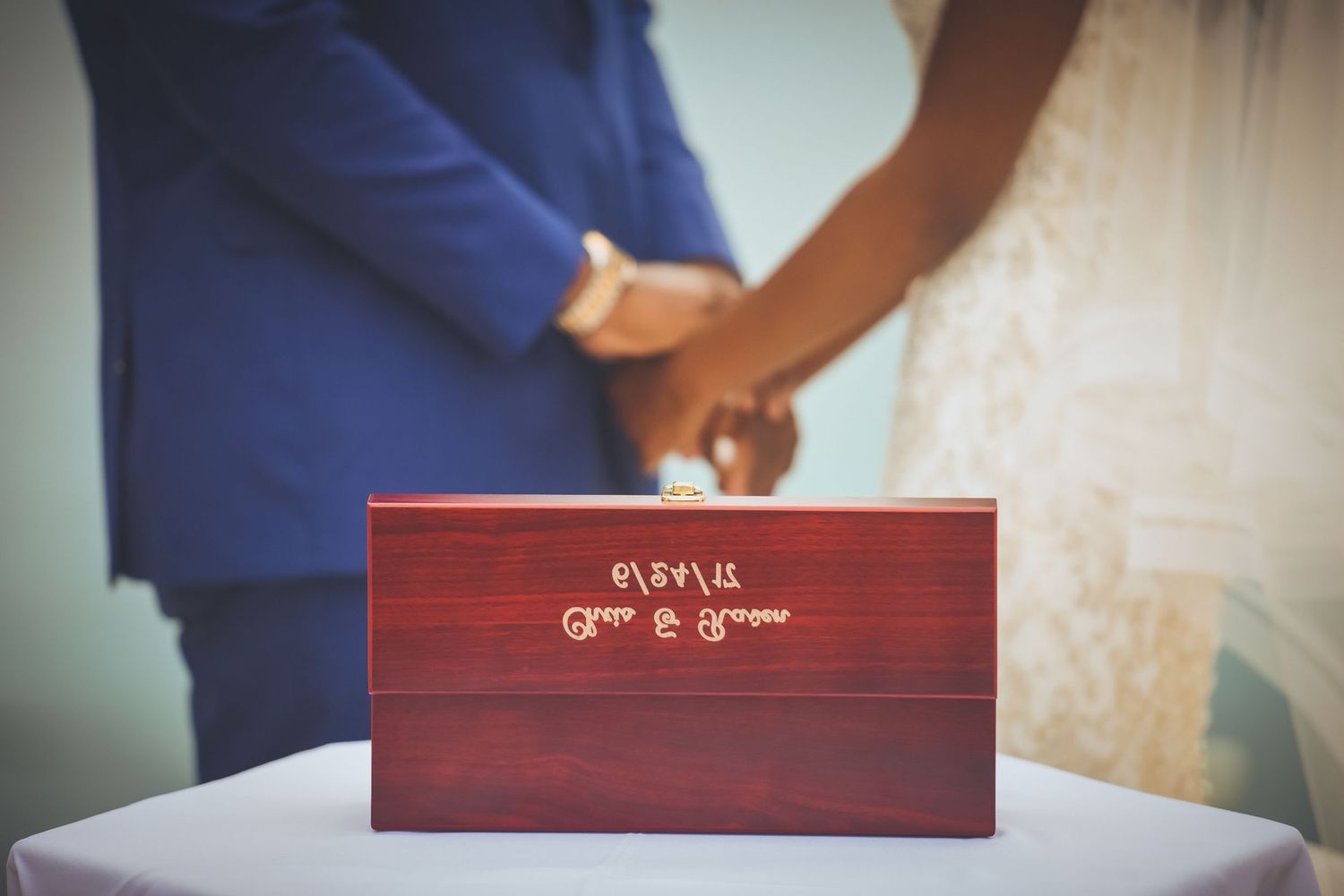 Close-up of a wooden box with 'Refill' text during a wedding ceremony.