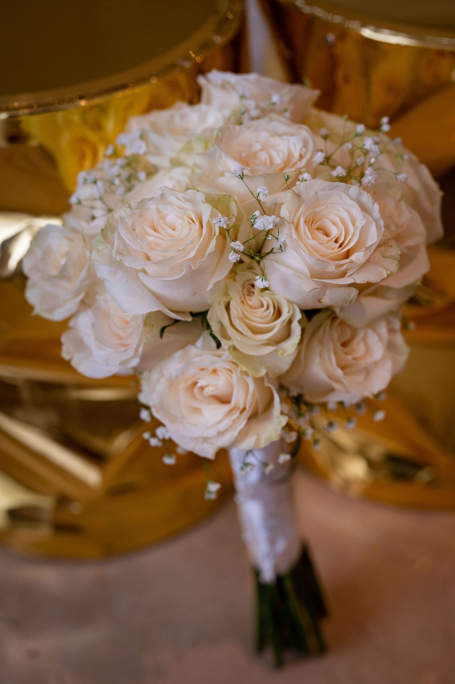 Delicate blush pink roses arranged in a wedding bouquet.