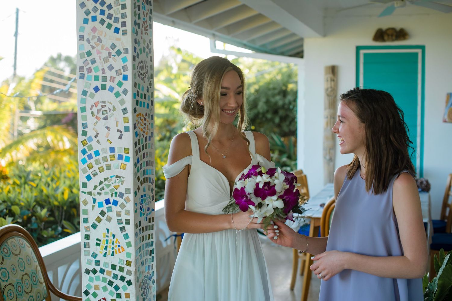 Tropical wedding venue with bright turquoise details and natural lighting.
