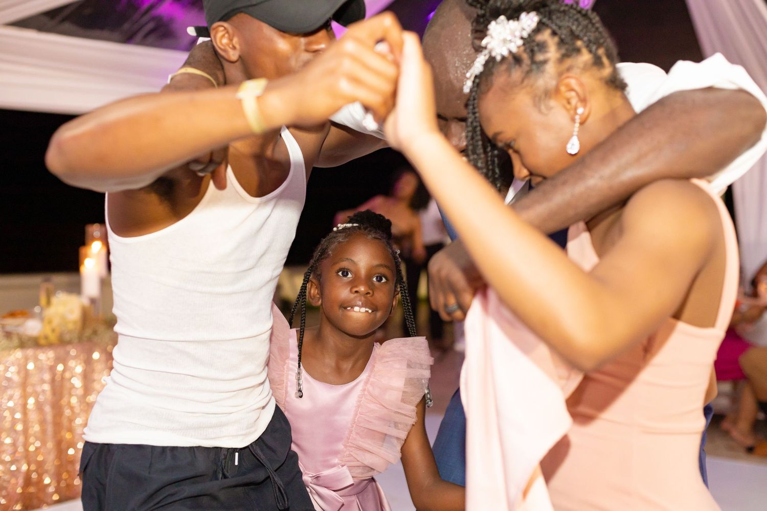 Wedding party celebrates with dancing and money throwing at an indoor reception.
