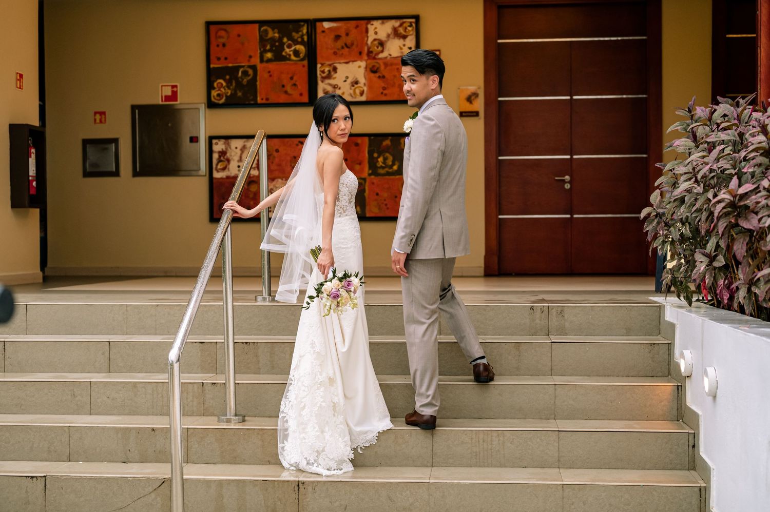 A wedding photo sequence showing a couple walking along steps with decorative wall art.