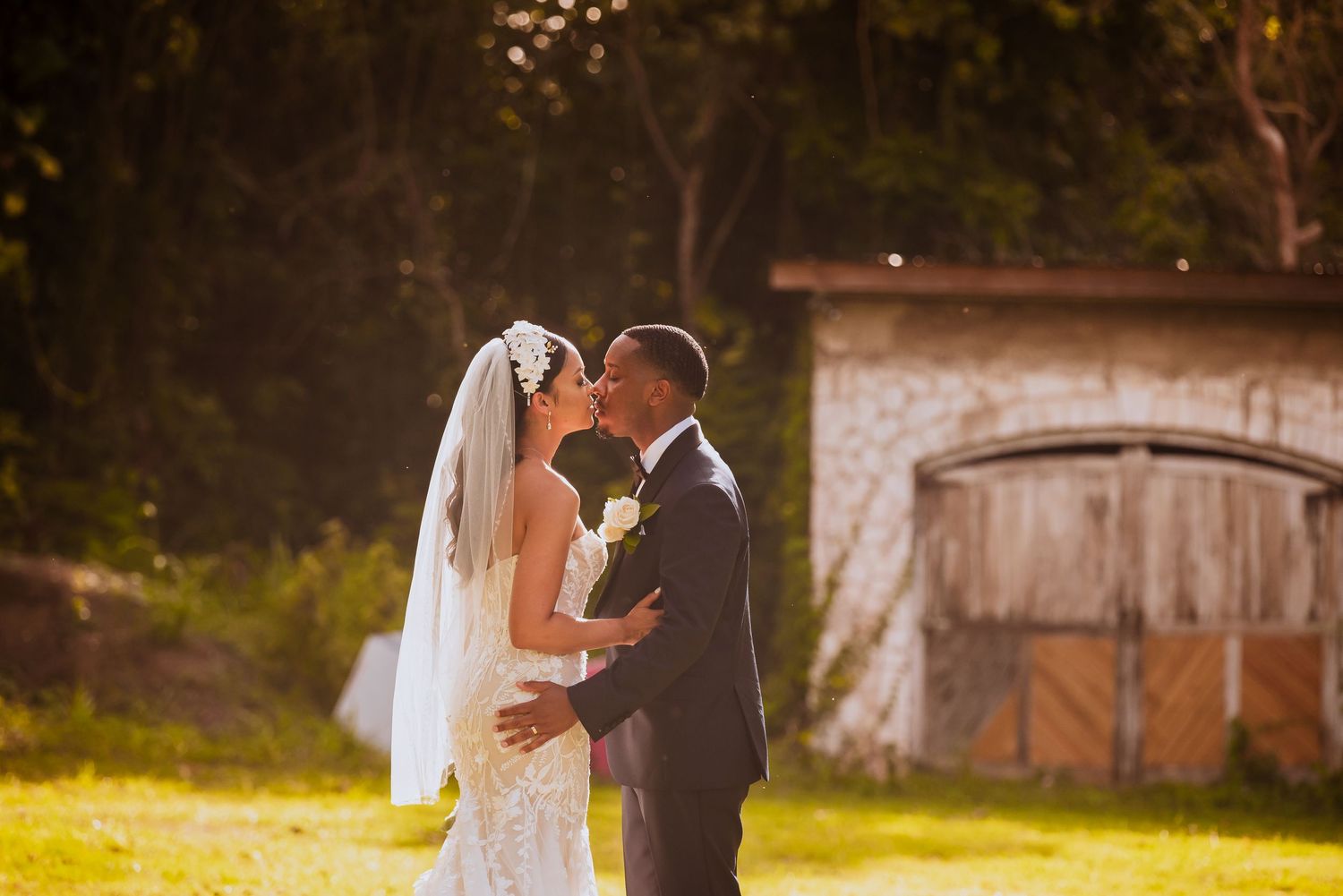 Sunset wedding portrait with rustic barn doors in the background.