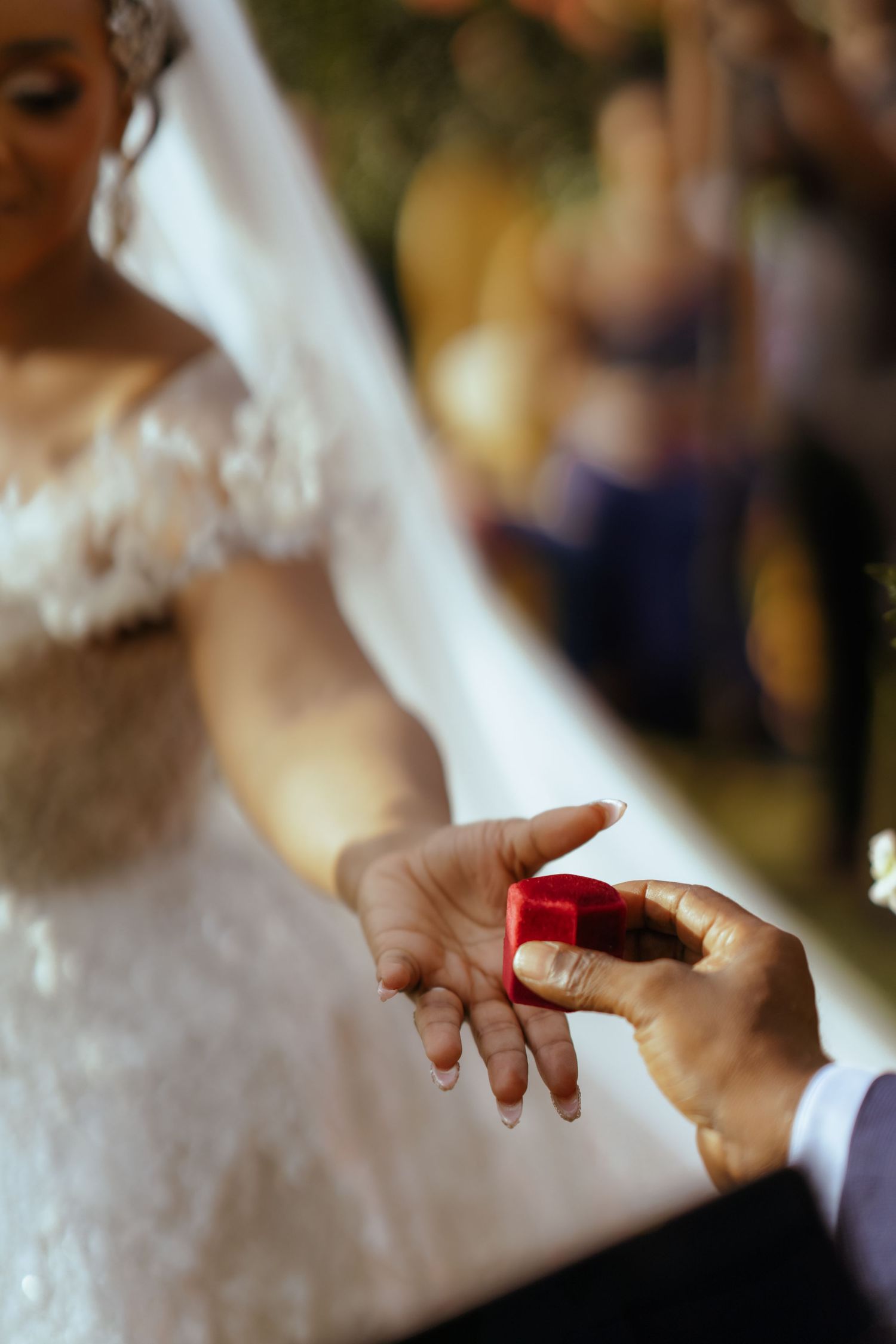 Close-up view of hands touching during an intimate wedding ceremony moment.