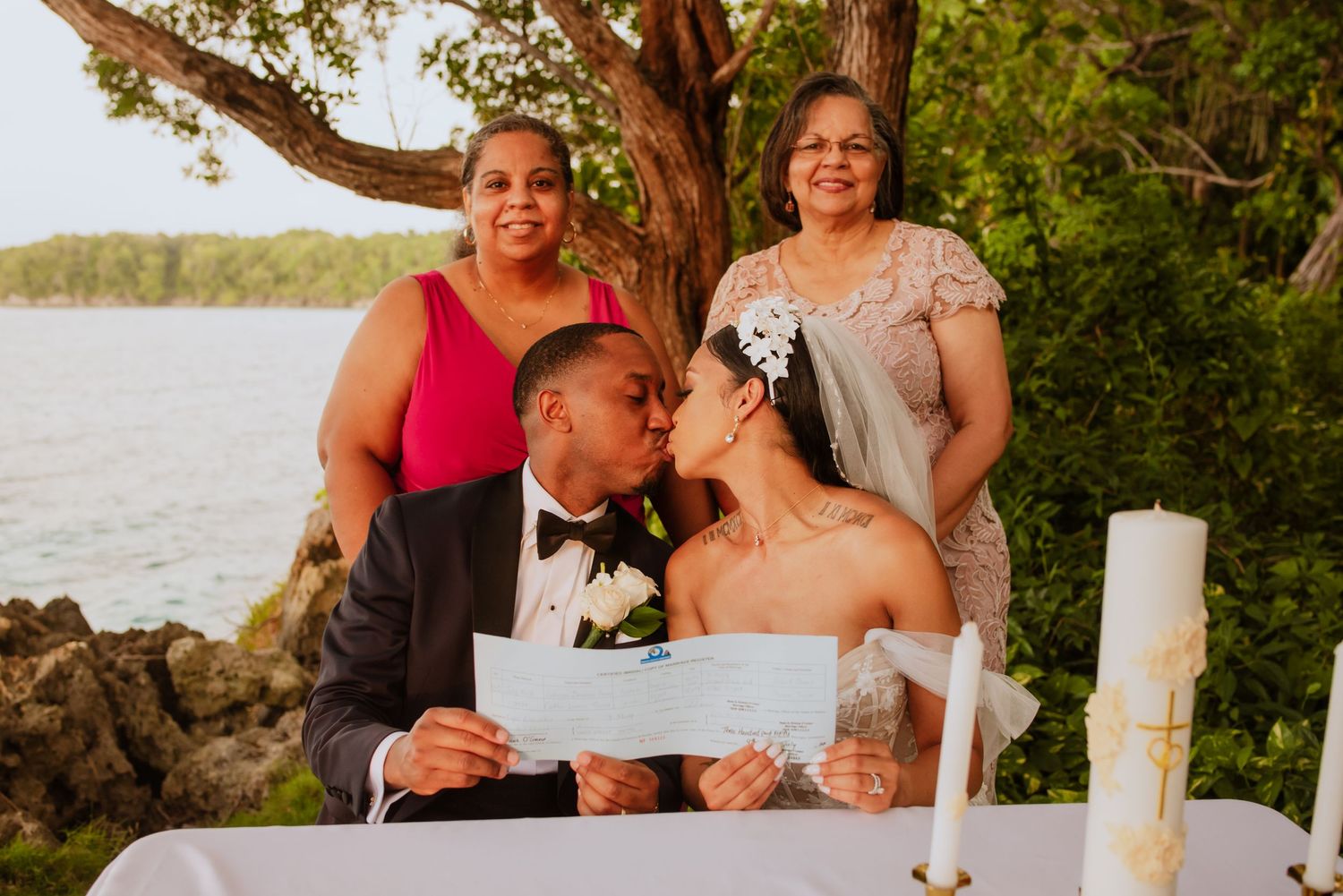 Intimate wedding ceremony moments shared under garden archway with guests.