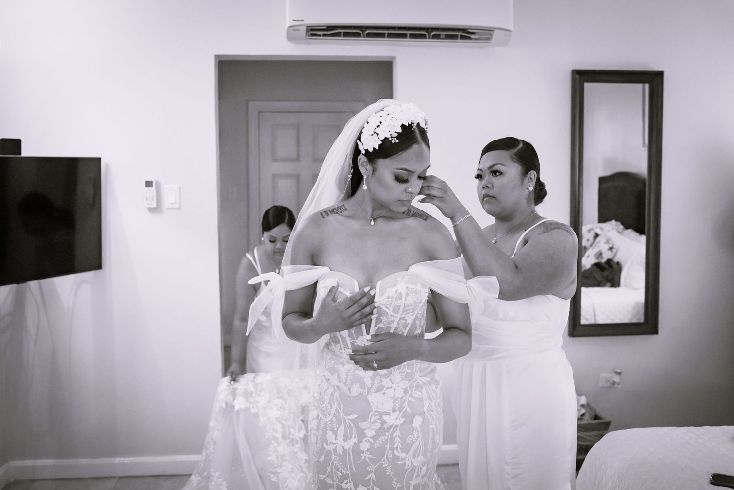 Black and white photos show wedding preparations in a bright room.
