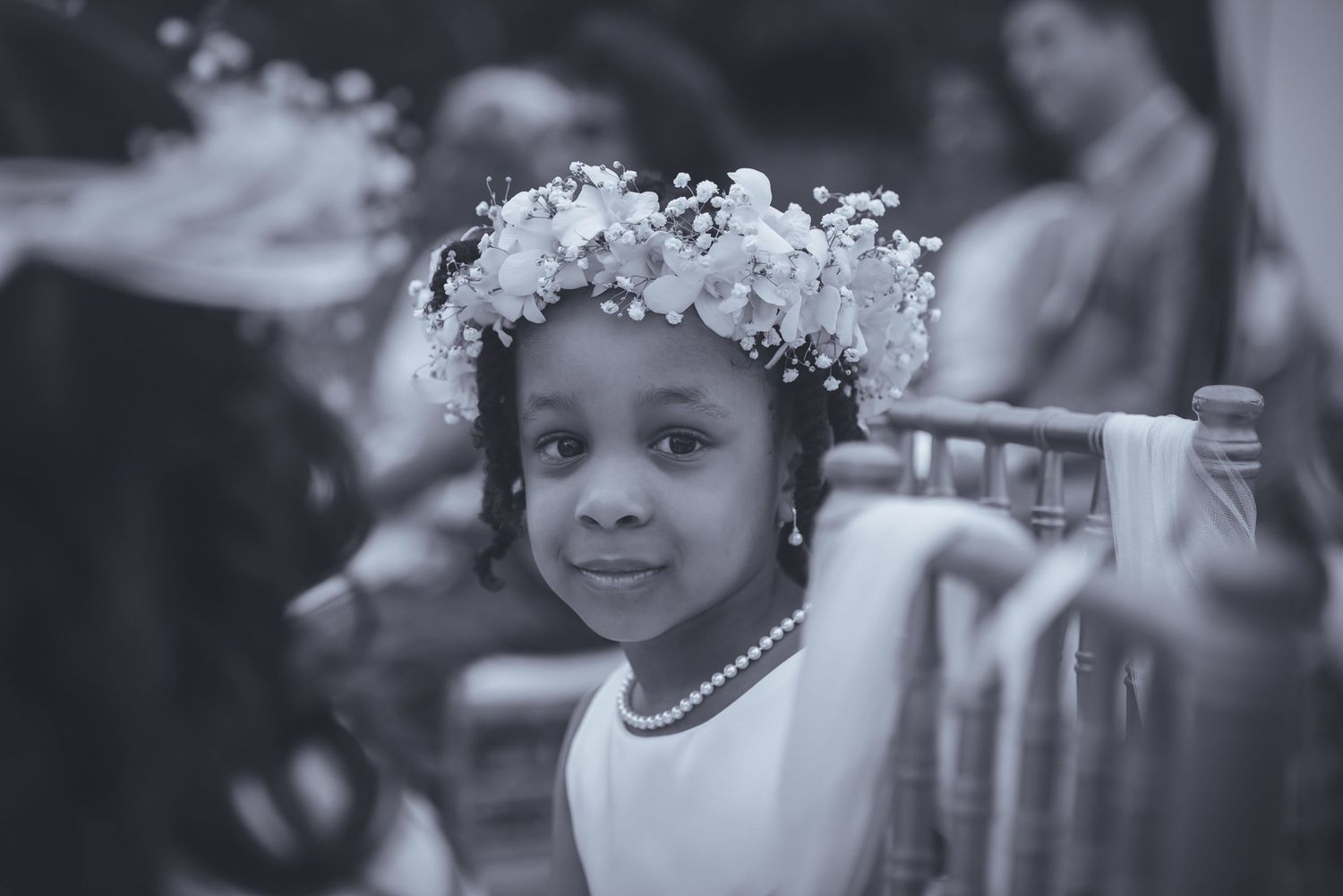 Black and white portrait of wedding guests during an outdoor celebration.