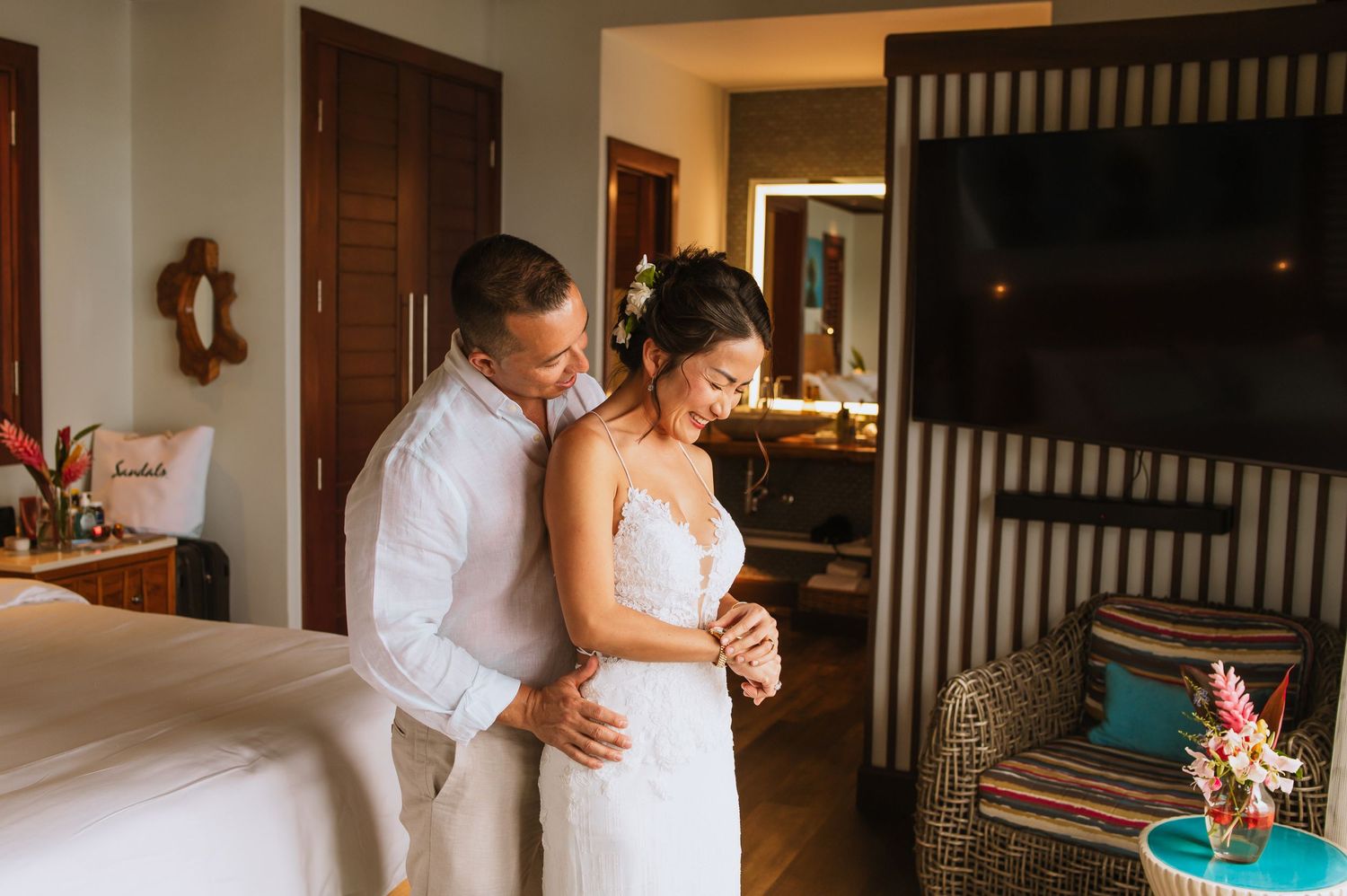 A couple shares an intimate dance moment in a rustic villa bedroom.