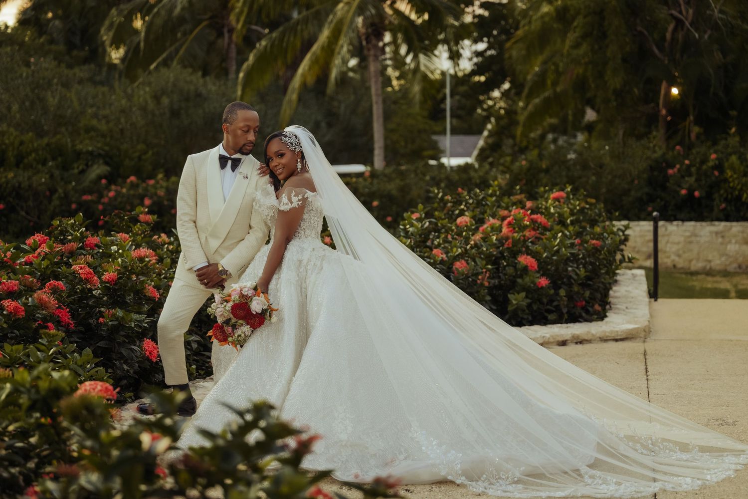 Romantic wedding portraits captured at sunset among tropical garden landscapes.