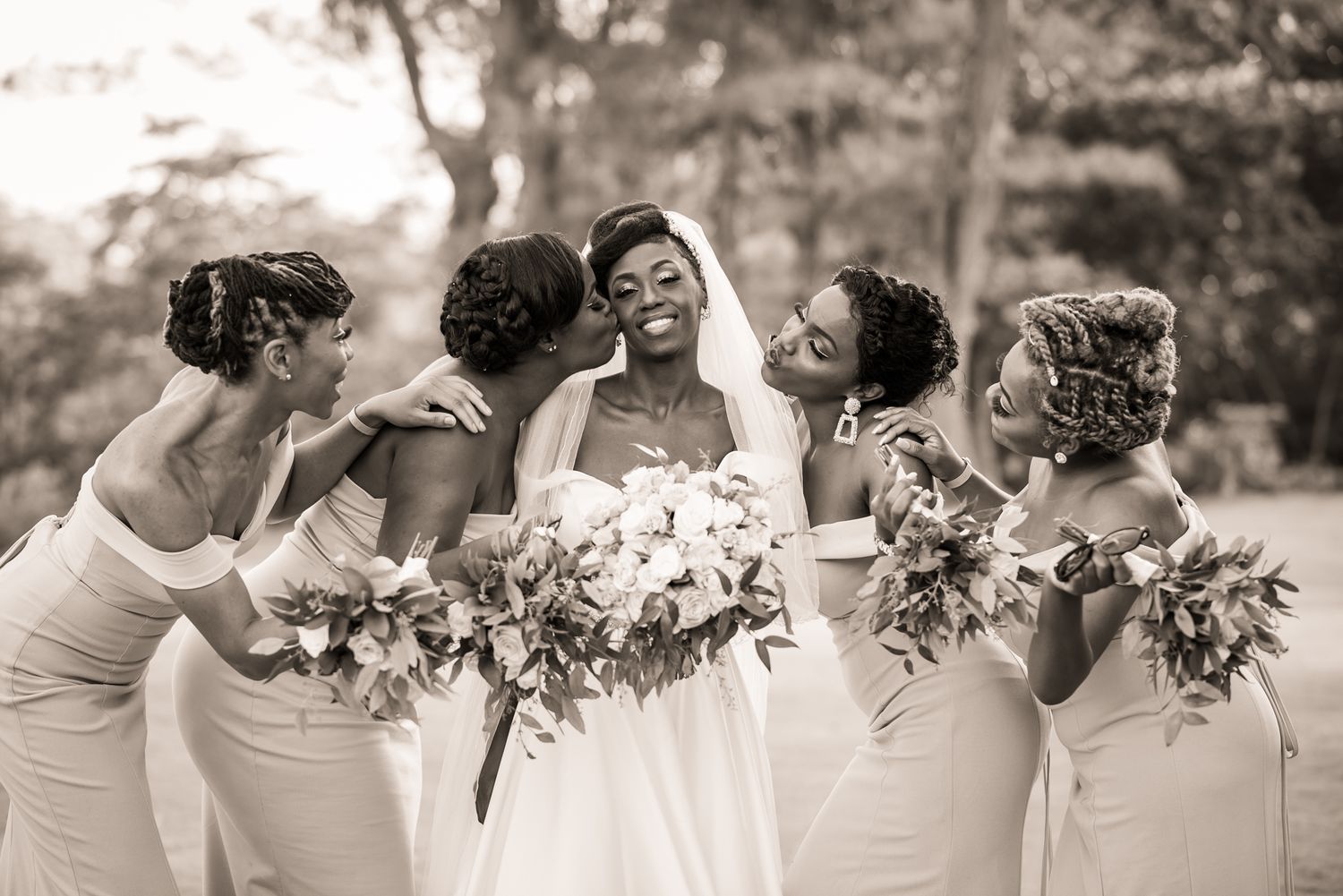 Wedding party laughs together in a candid black and white photo sequence.
