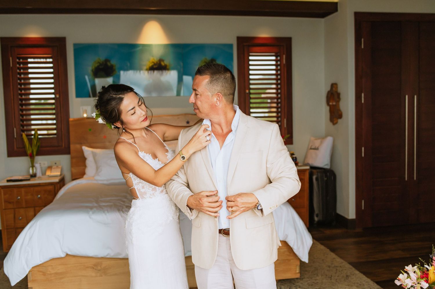 Couple shares tender moments in an elegant resort setting with ocean views.