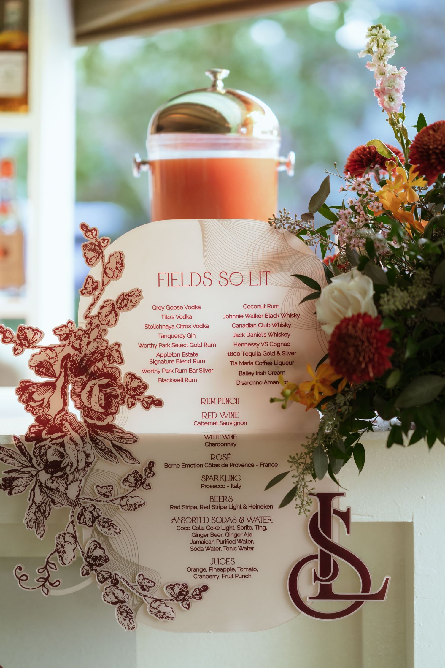 Floral wedding program with burgundy design details and text layout.