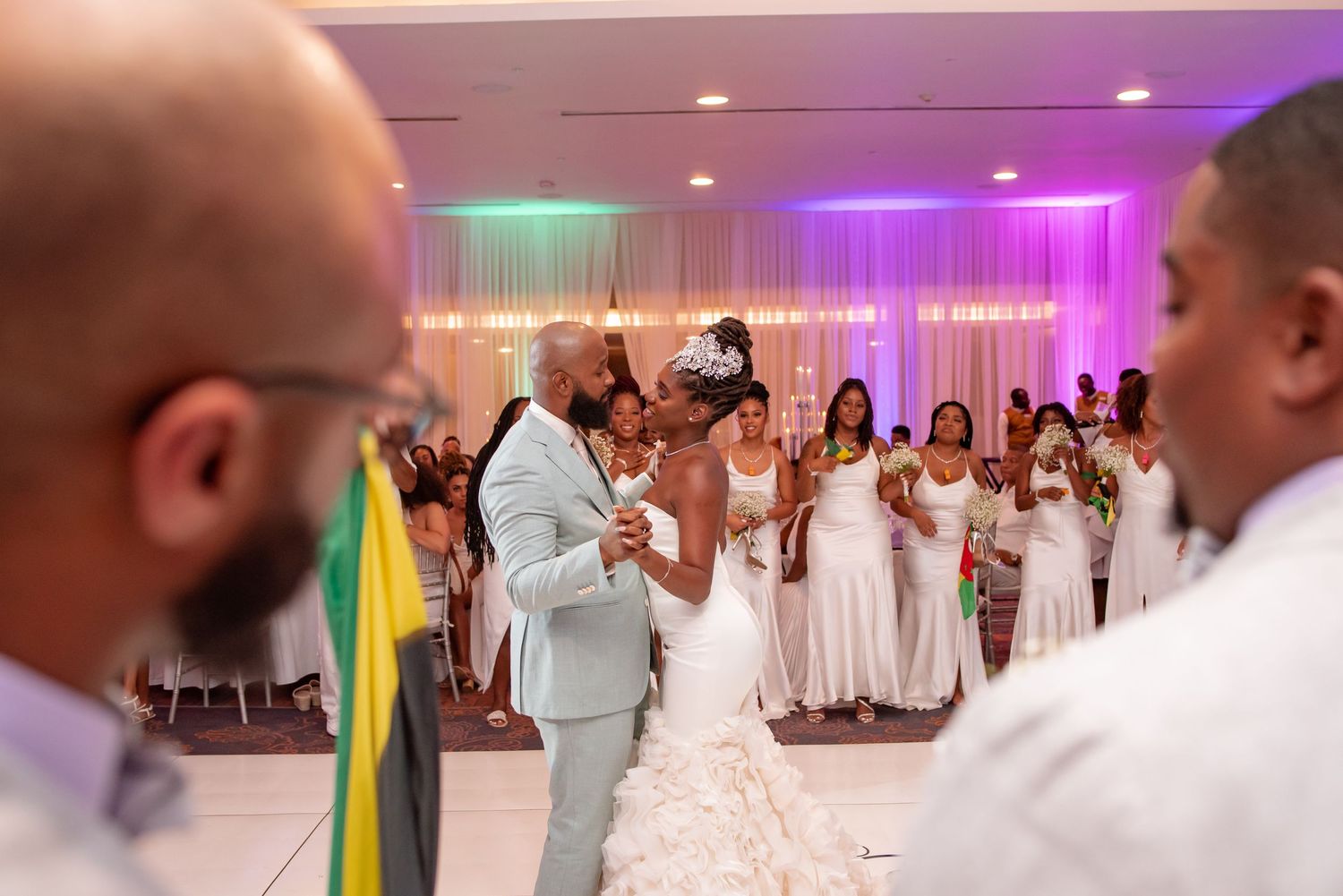 Wedding reception dance party with guests celebrating in a decorated ballroom.
