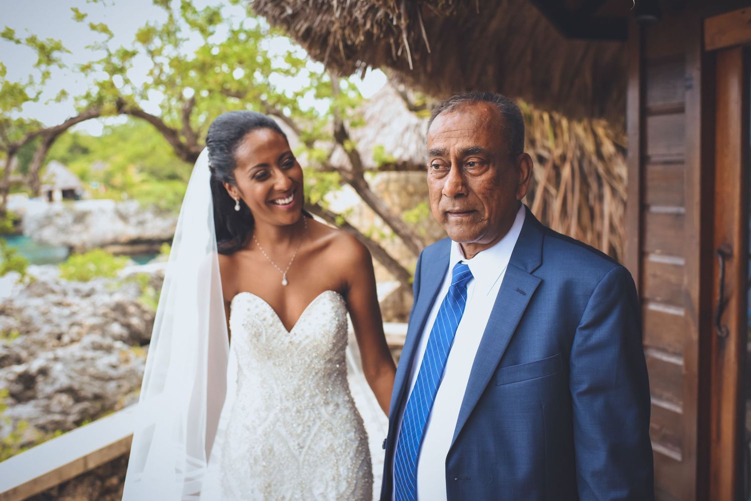 Intimate wedding portraits taken at a beachside venue with wooden architectural details.