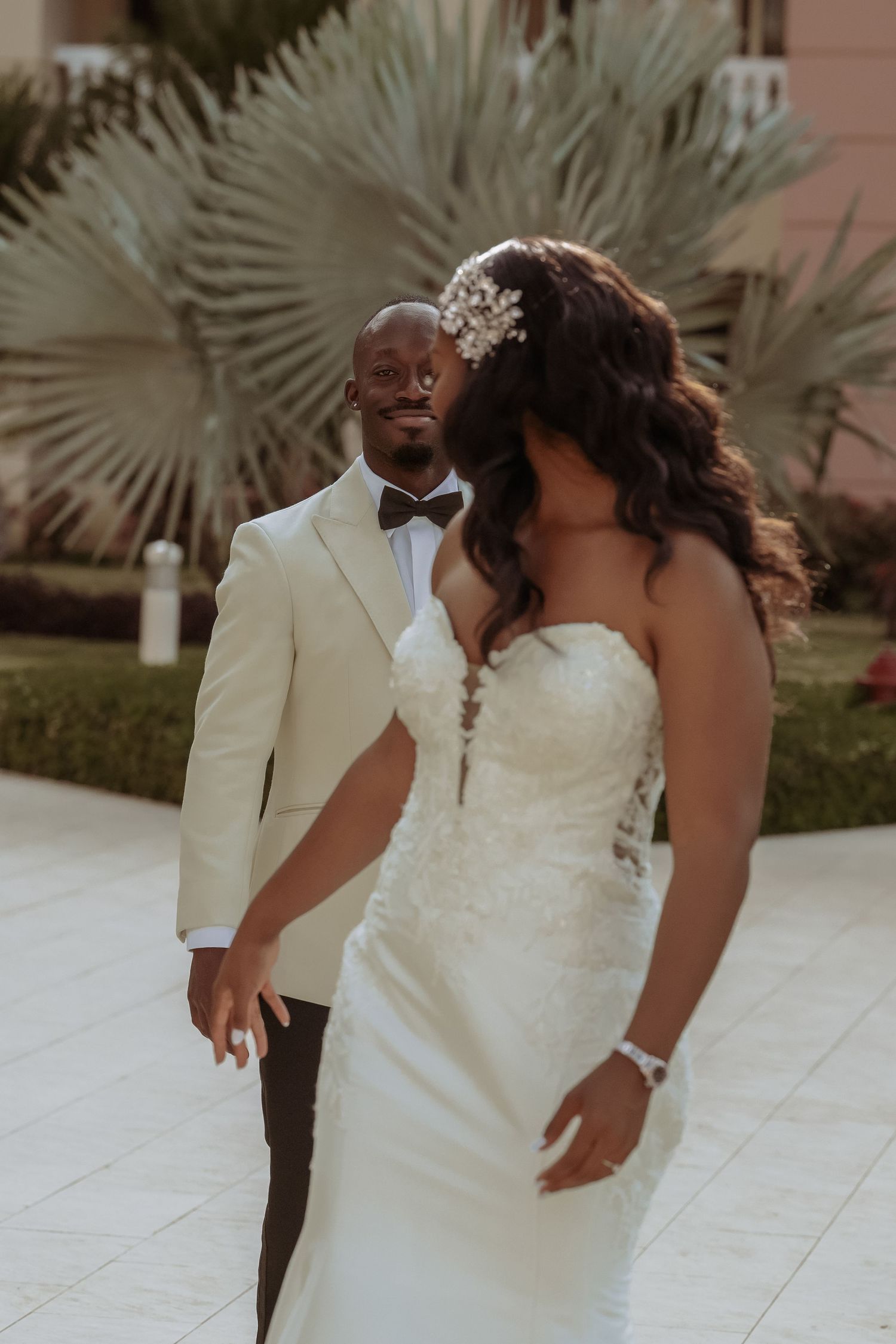 Newlywed couple in white dress and suit share intimate moments during their wedding photo session.
