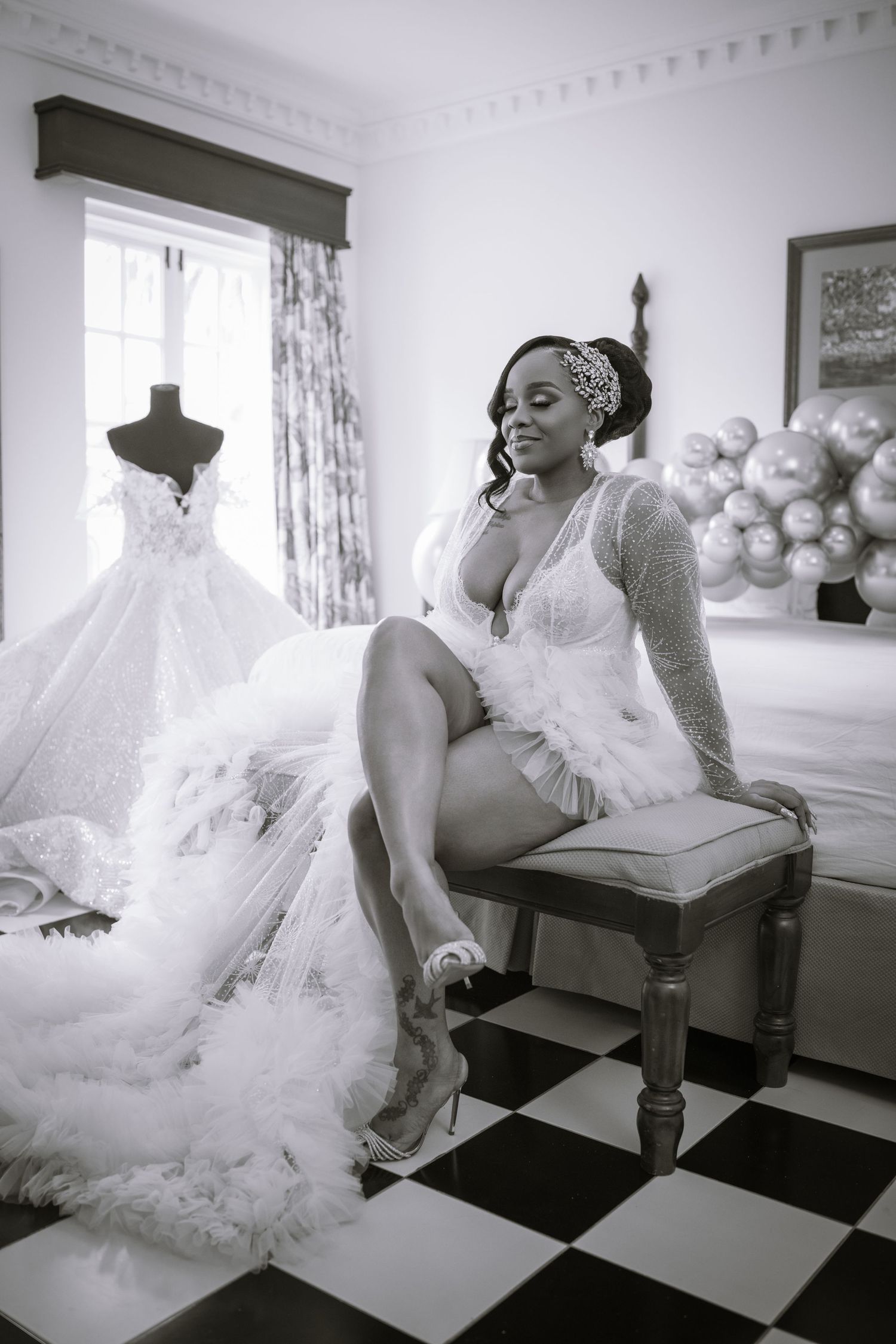Black and white photos of a bride in a luxurious wedding gown posing on vintage furniture.