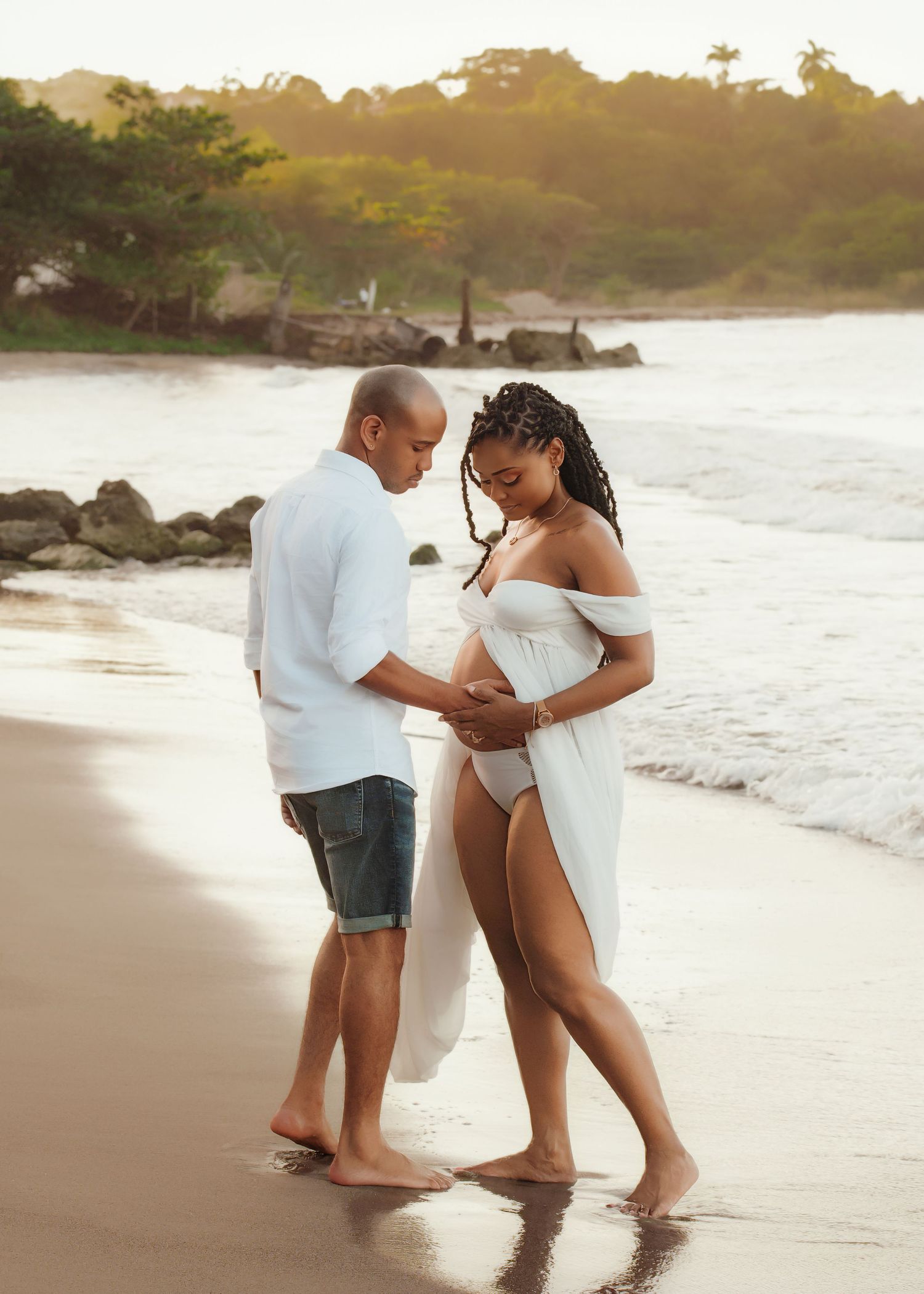 Couple sharing intimate moment on beach at sunset.