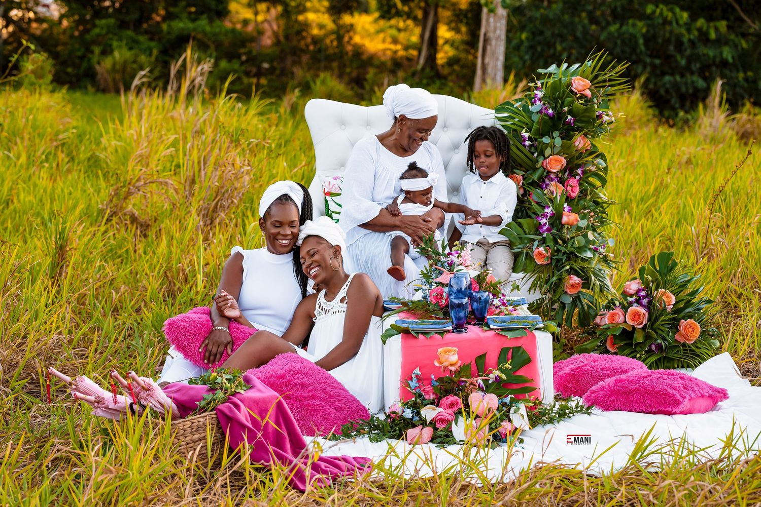 Couple enjoying picnic setup with flowers in sunny meadow.