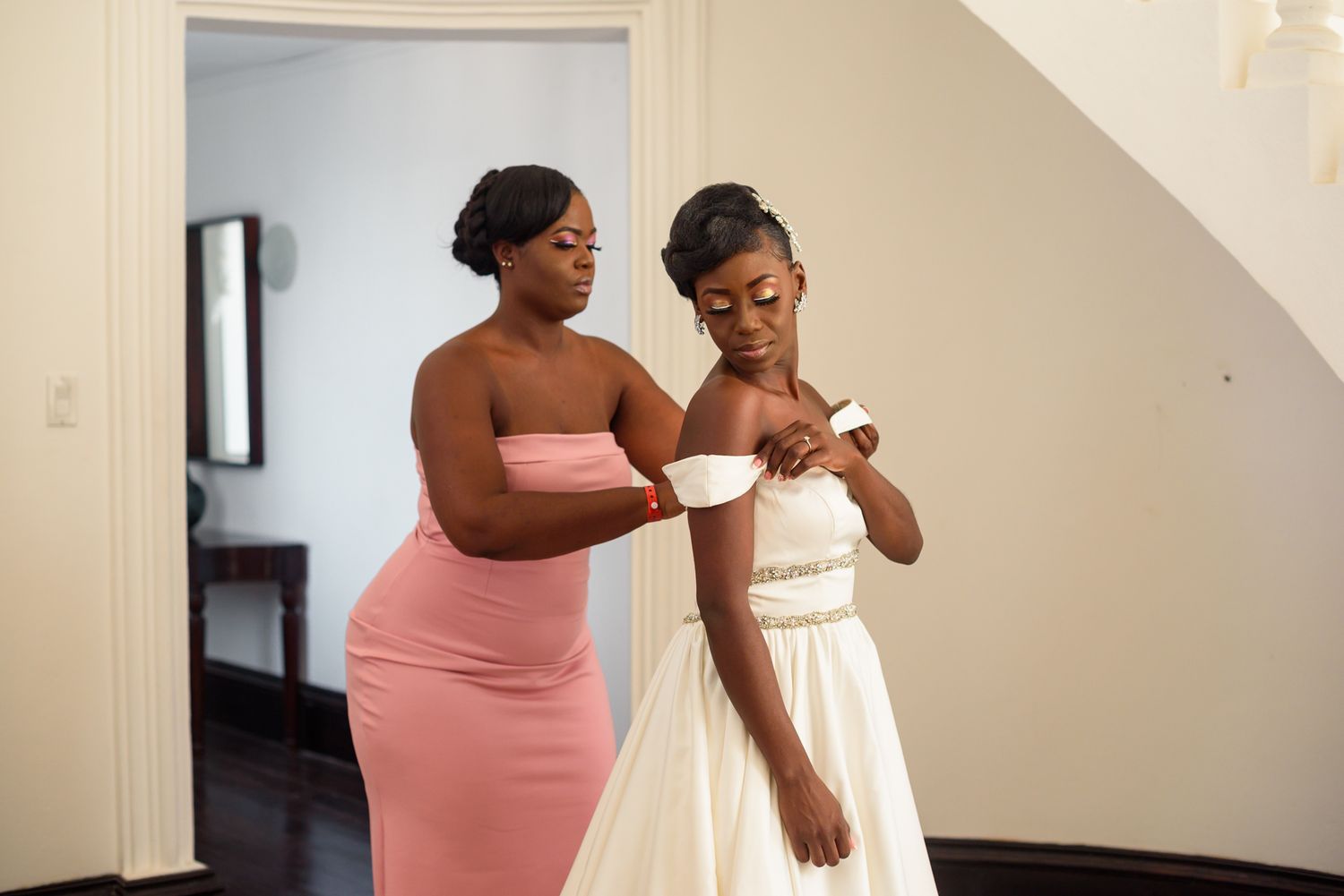 A tender moment between two people during a wedding dress fitting session.