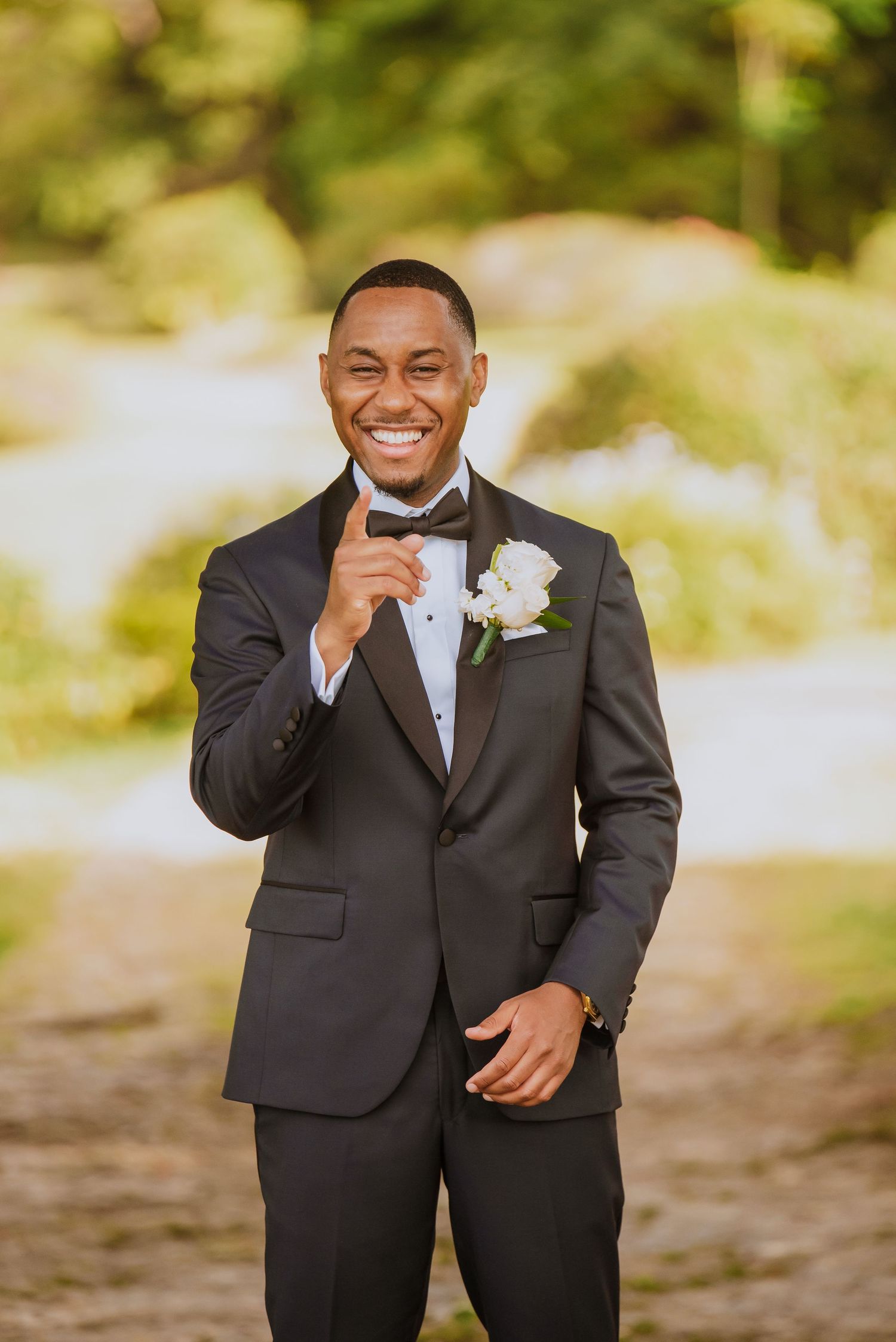 Person in black tuxedo showing emotional reactions during a wedding first look.