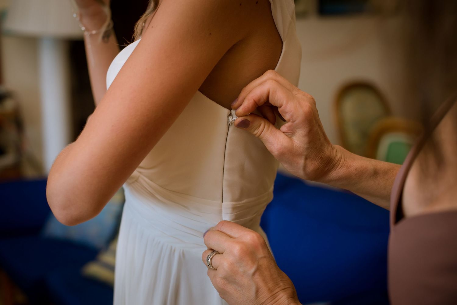Close-up details of wedding dress preparations and adjustments.