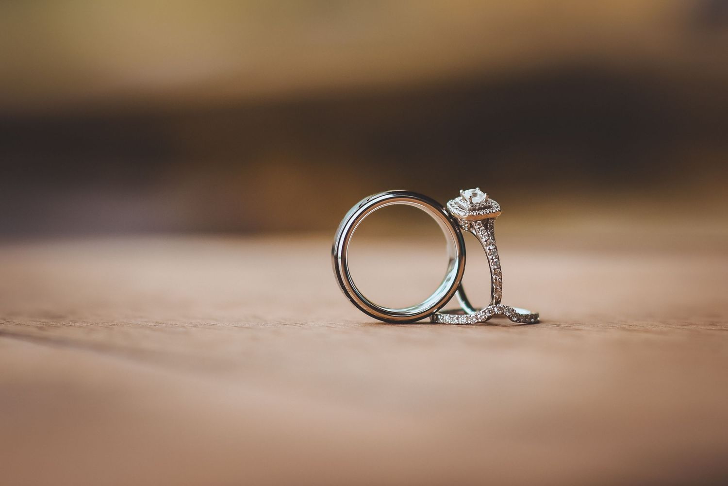 Wedding rings photographed in soft focus with blurred background.