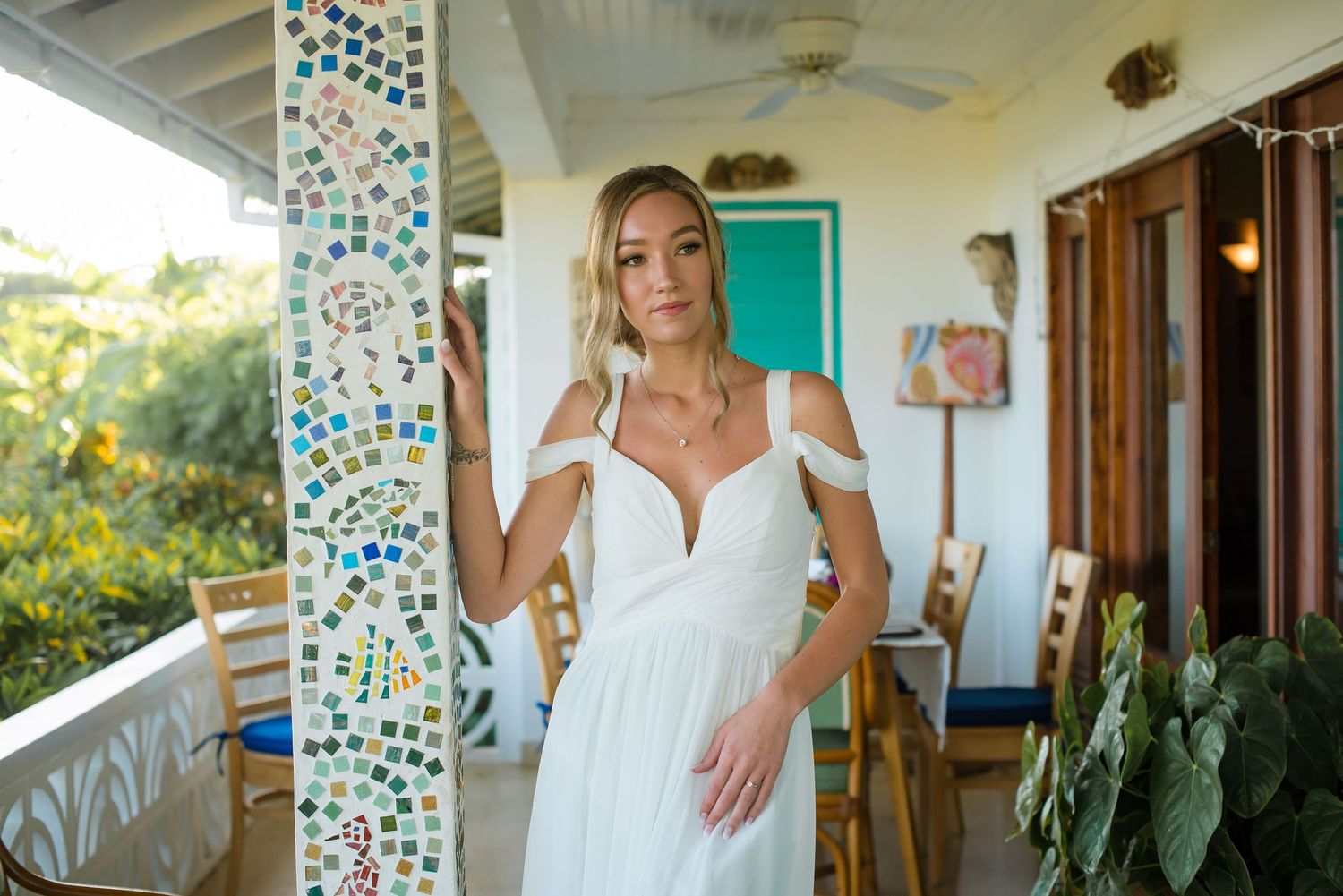 Wedding venue interior featuring turquoise decor and mosaic tile columns.