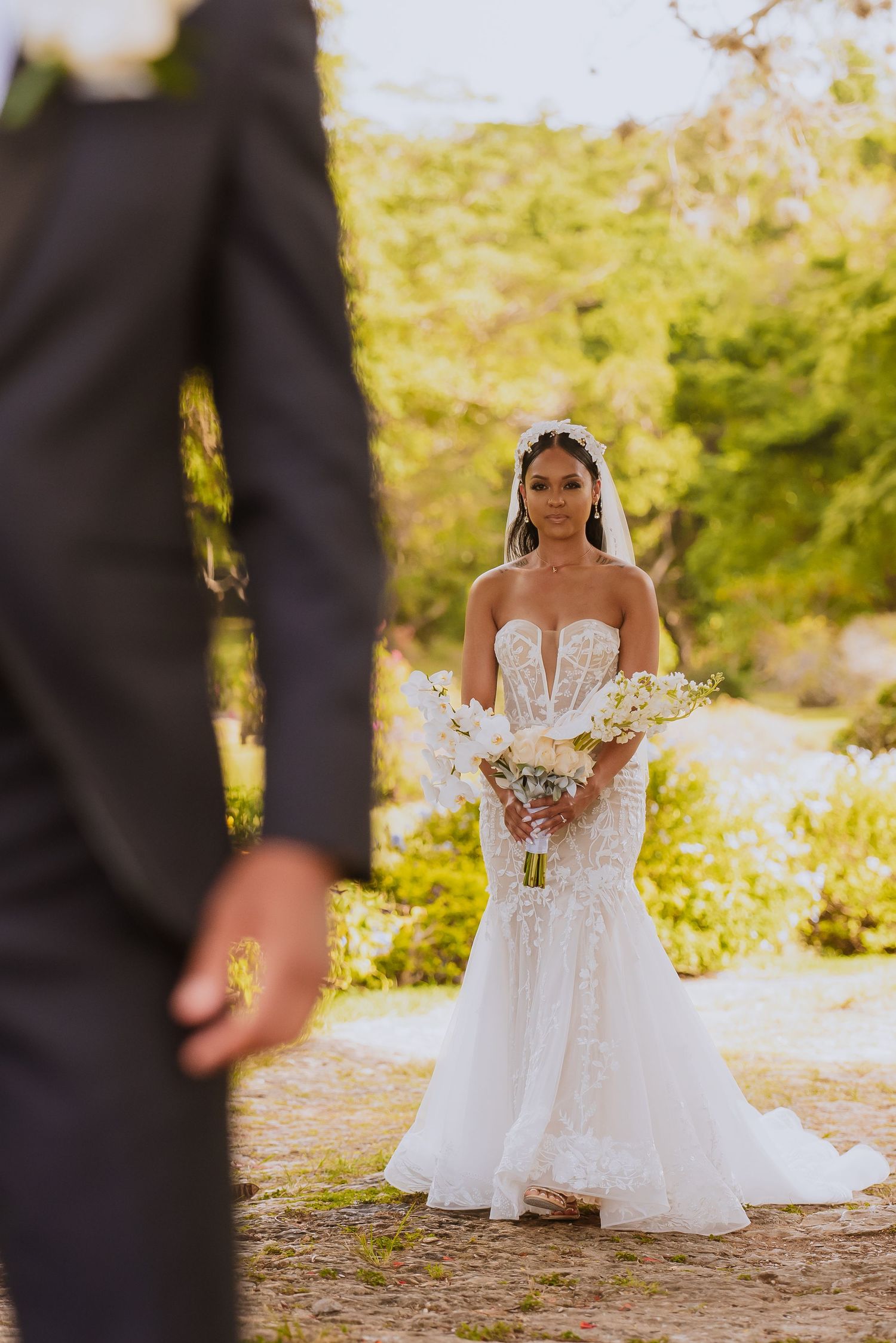 Elegant bride in white lace gown photographed from various angles in a garden setting.