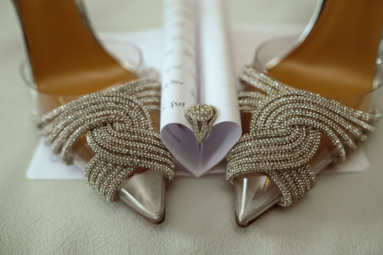White wedding shoes with delicate beaded embellishments and crystal details arranged in a stylish display.