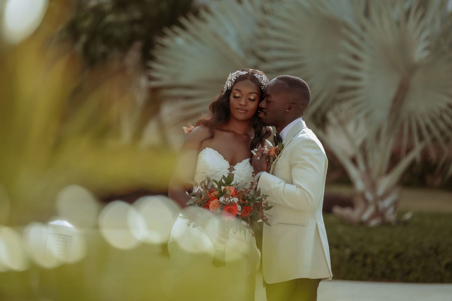 Intimate wedding moments captured in a series of romantic outdoor portraits with palm trees in the background.