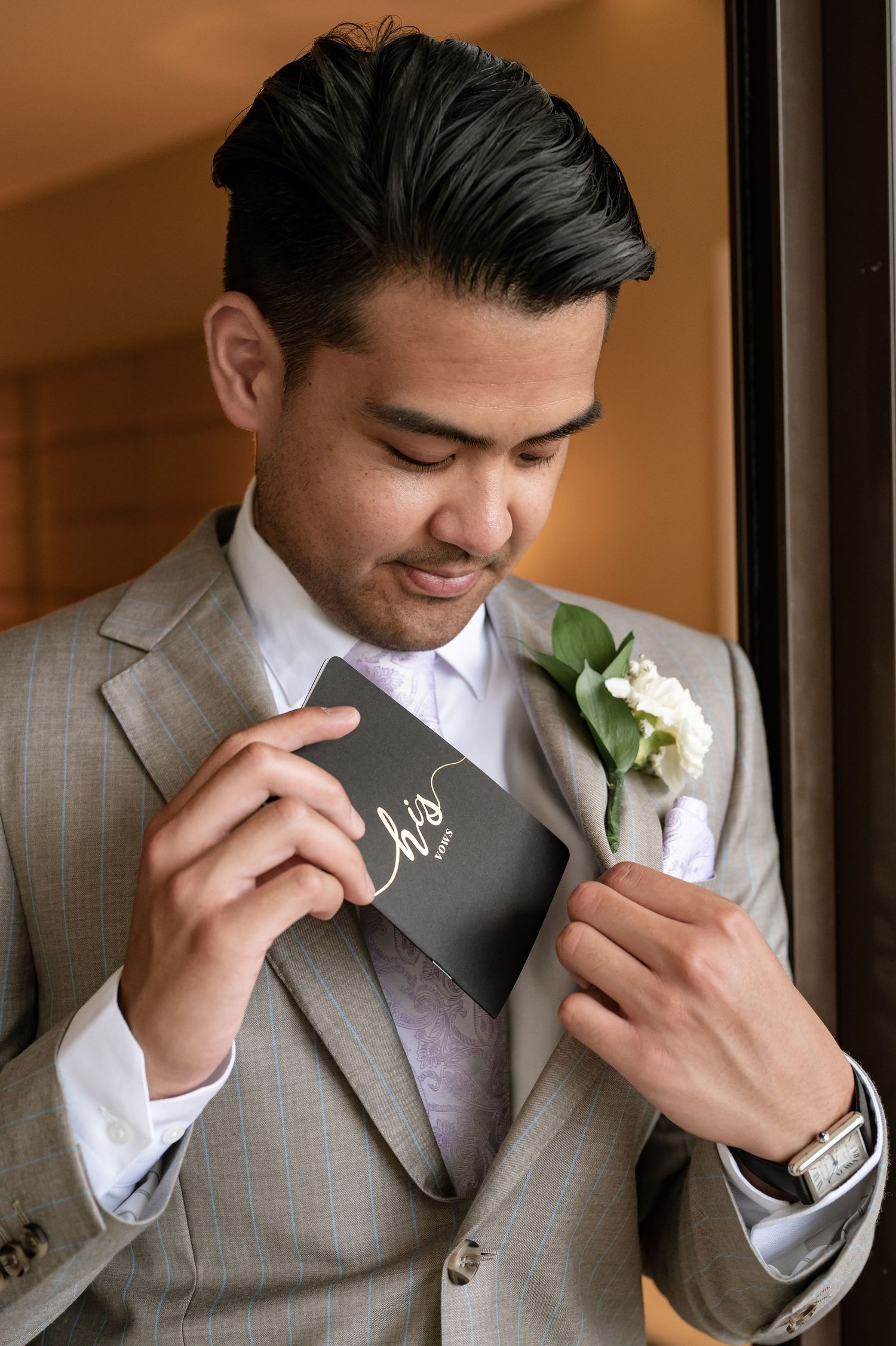 Emotional moment as groom reads personal vows before ceremony.