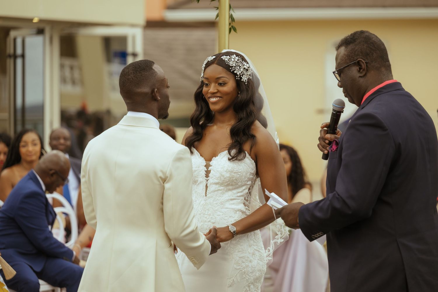Wedding celebration scene with guests and couple during indoor reception.