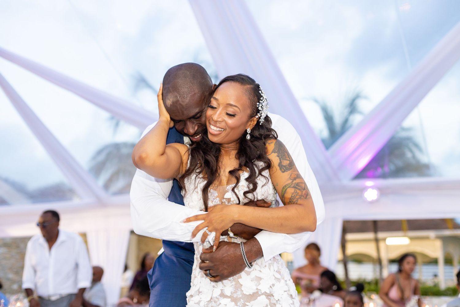 Joyful dancing and celebration at a beachside wedding reception.