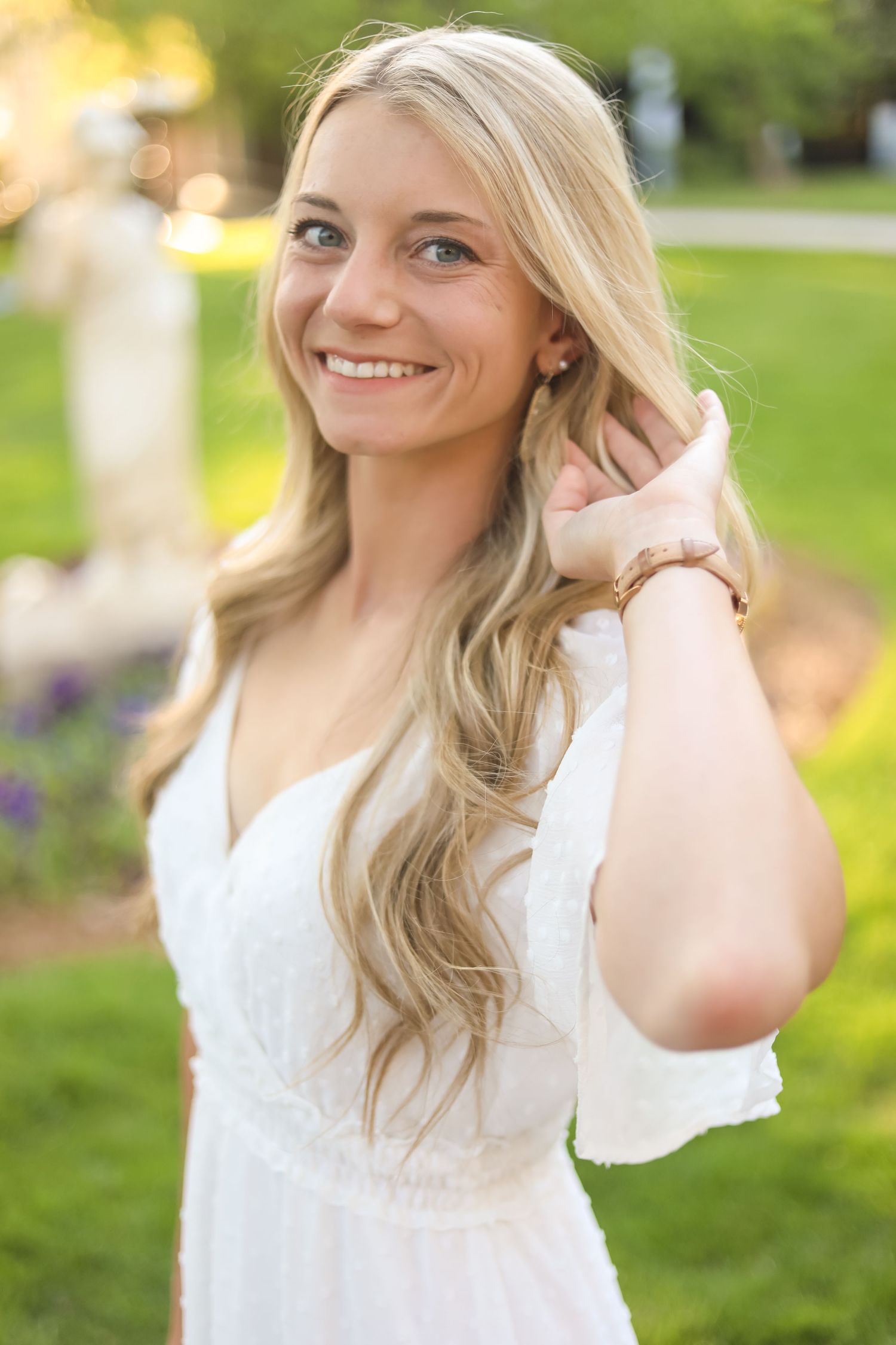 Natural outdoor portrait session in a garden with soft lighting and white lace details.