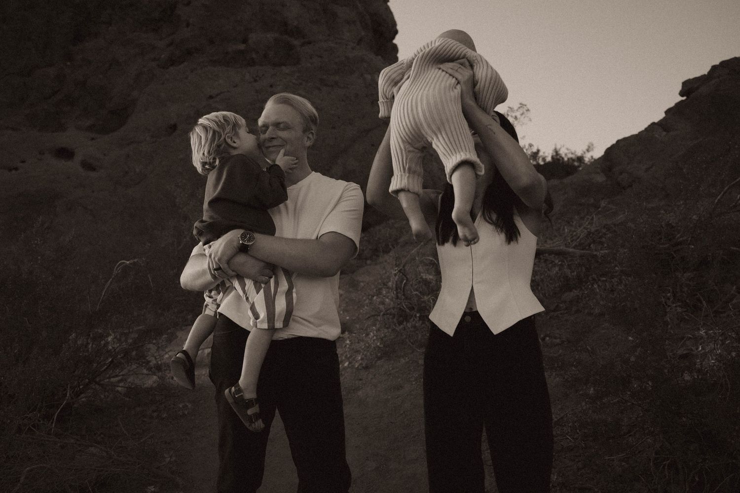 parents playfully interacting with their young kids during their papago park photoshoot in phoenix arizona