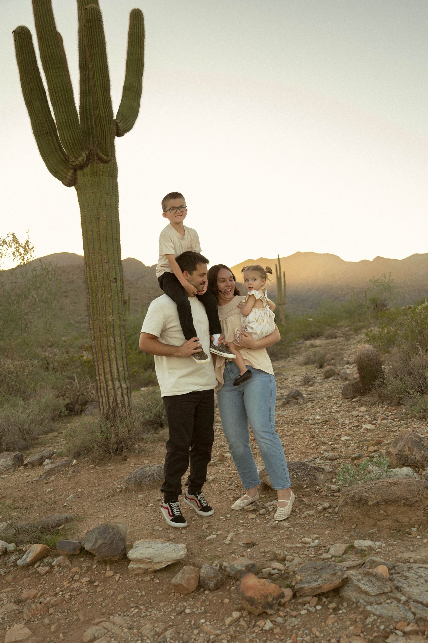 family with young kids laughing during their desert family photo session in phoenix arizona