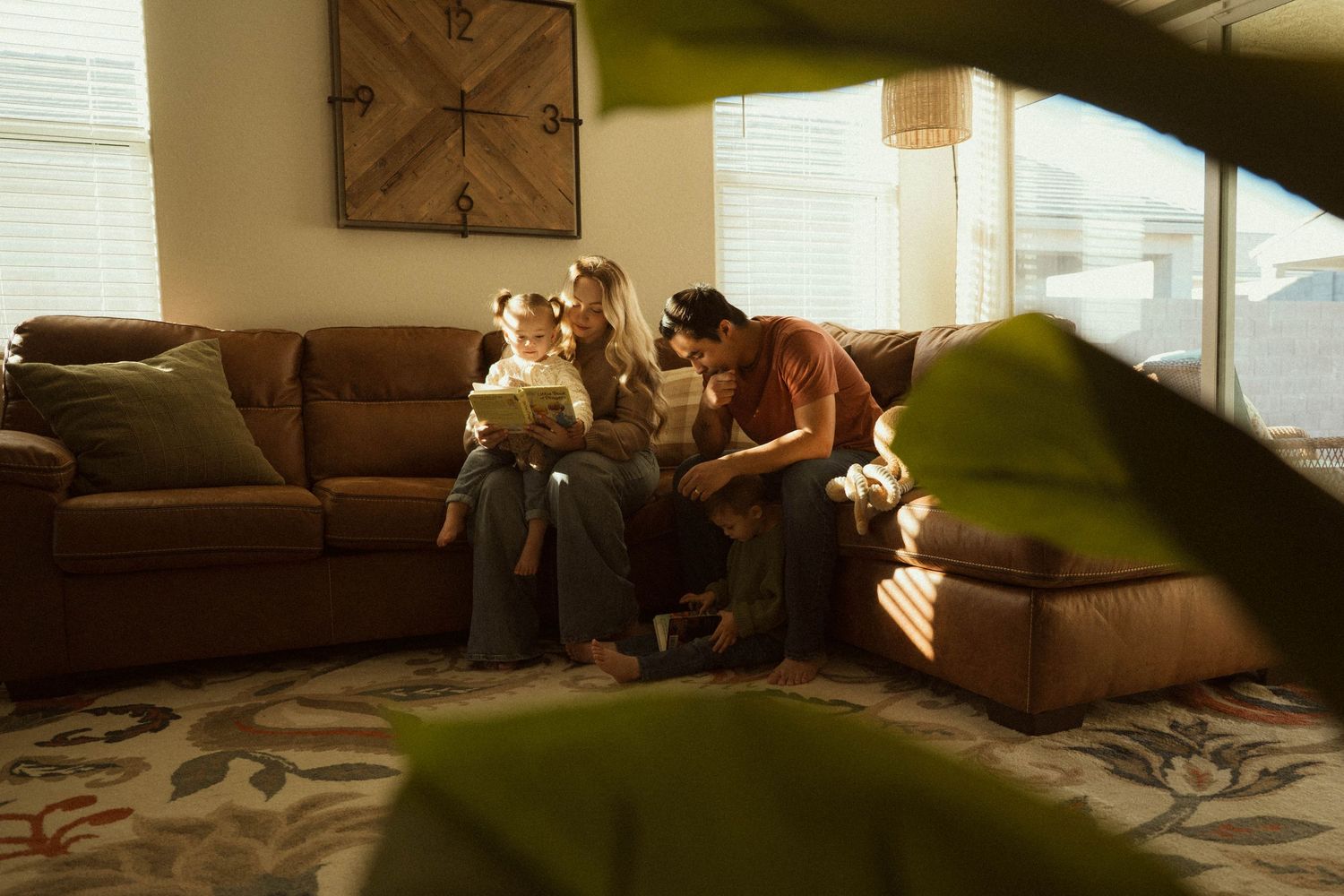 family with two kids reading books together at home in phoenix arizona