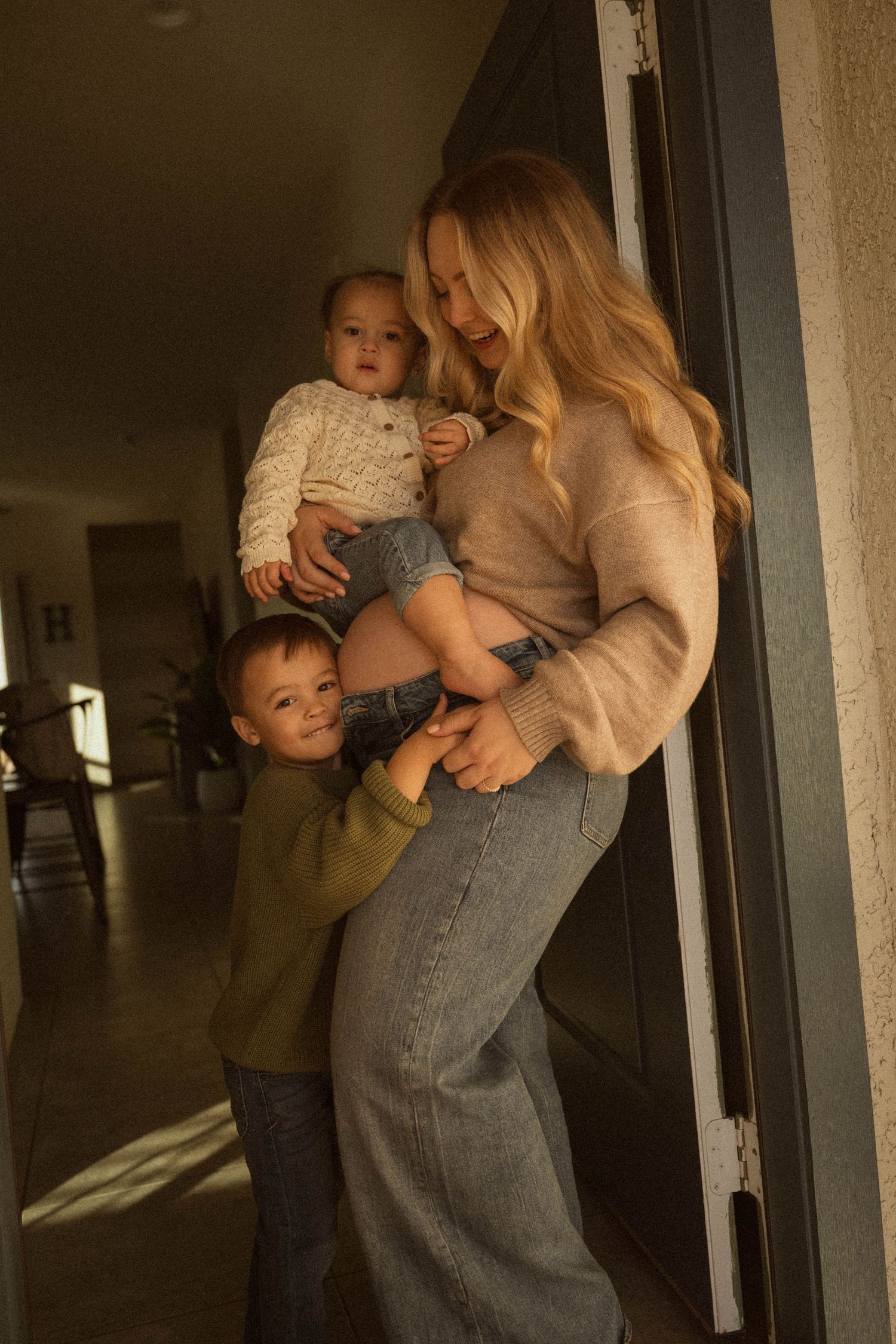 A series of intimate family moments showing a parent and child embracing in a dimly lit hallway.