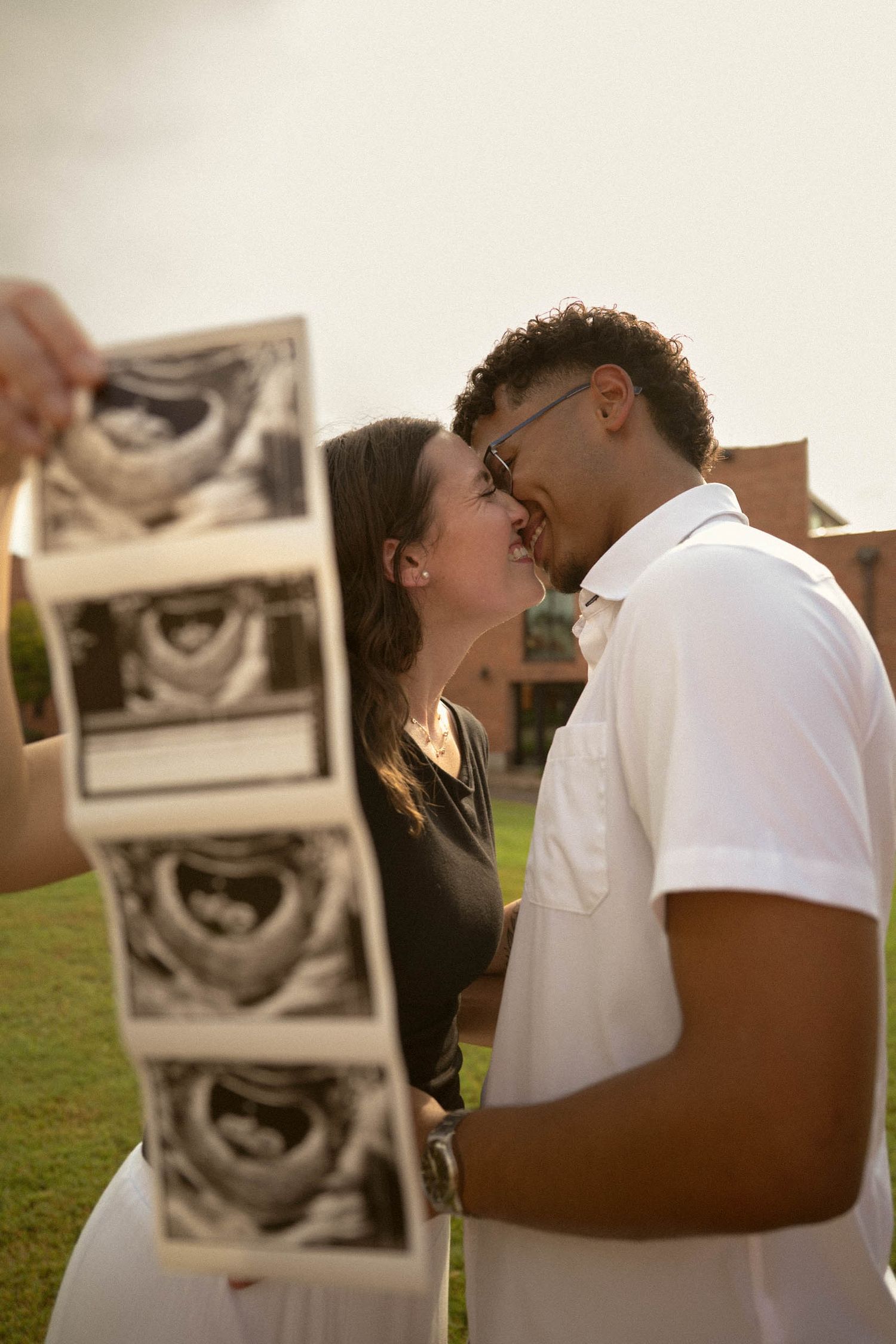 couple holding up their ultrasound during a pregnancy announcement shoot in phoenix arizona