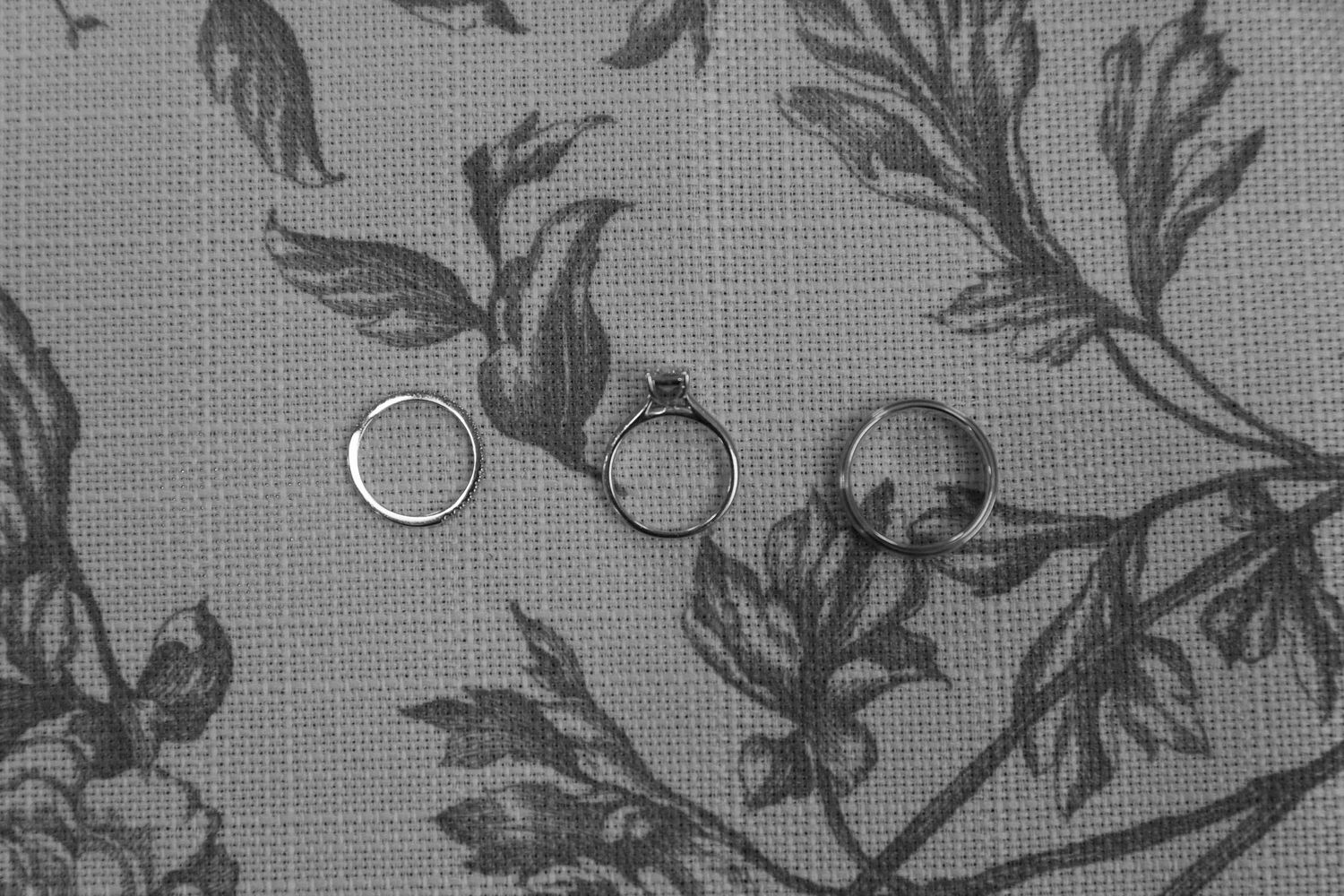 Delicate black and white floral pattern with leaves and branches creates an elegant vintage wallpaper design.